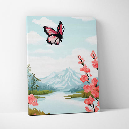 Butterfly lake pixel art canvas print with a pink butterfly above cherry blossoms and snow capped mountains