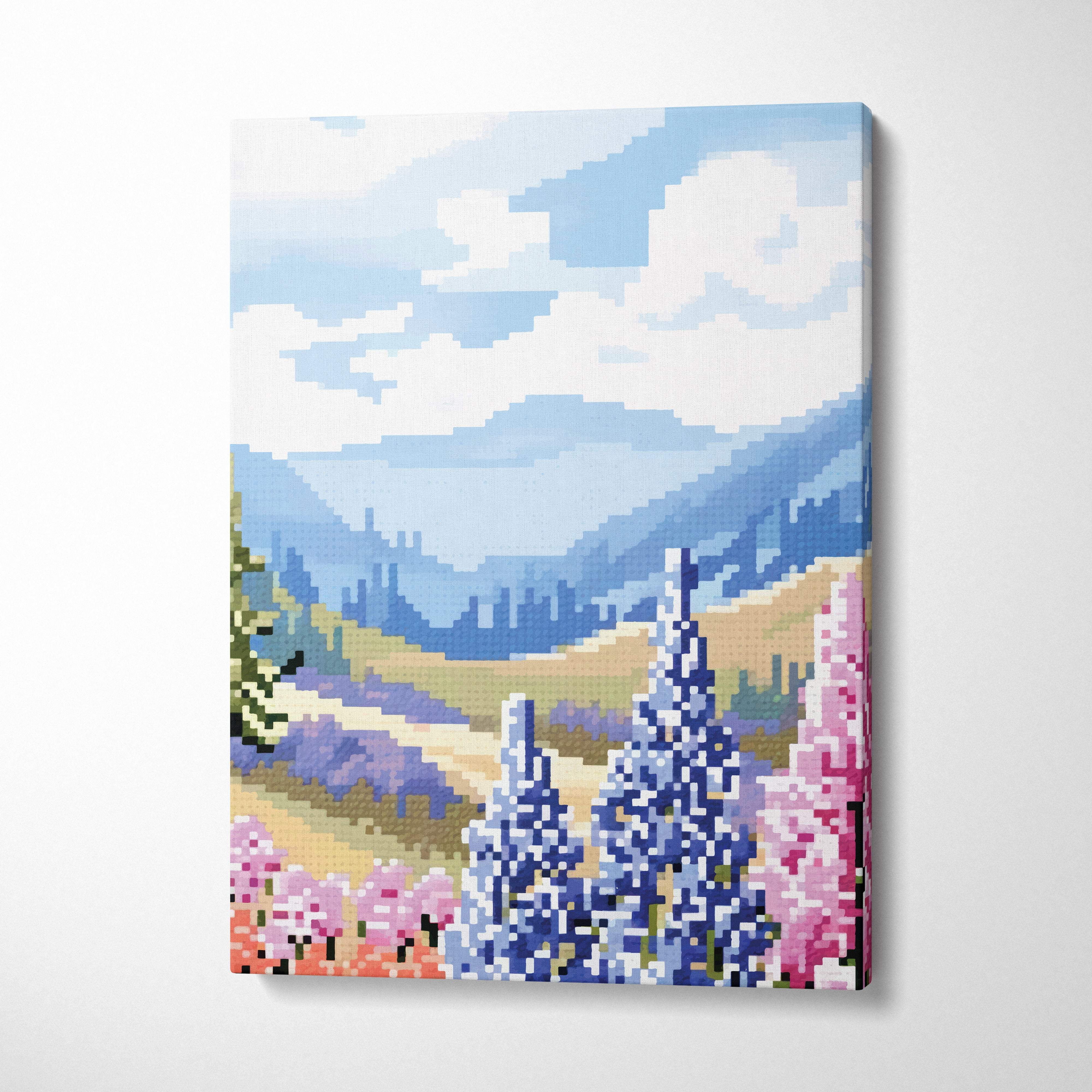 Pixelated canvas print of a mountain landscape with blue and pink flowers in the foreground for serene nature decor