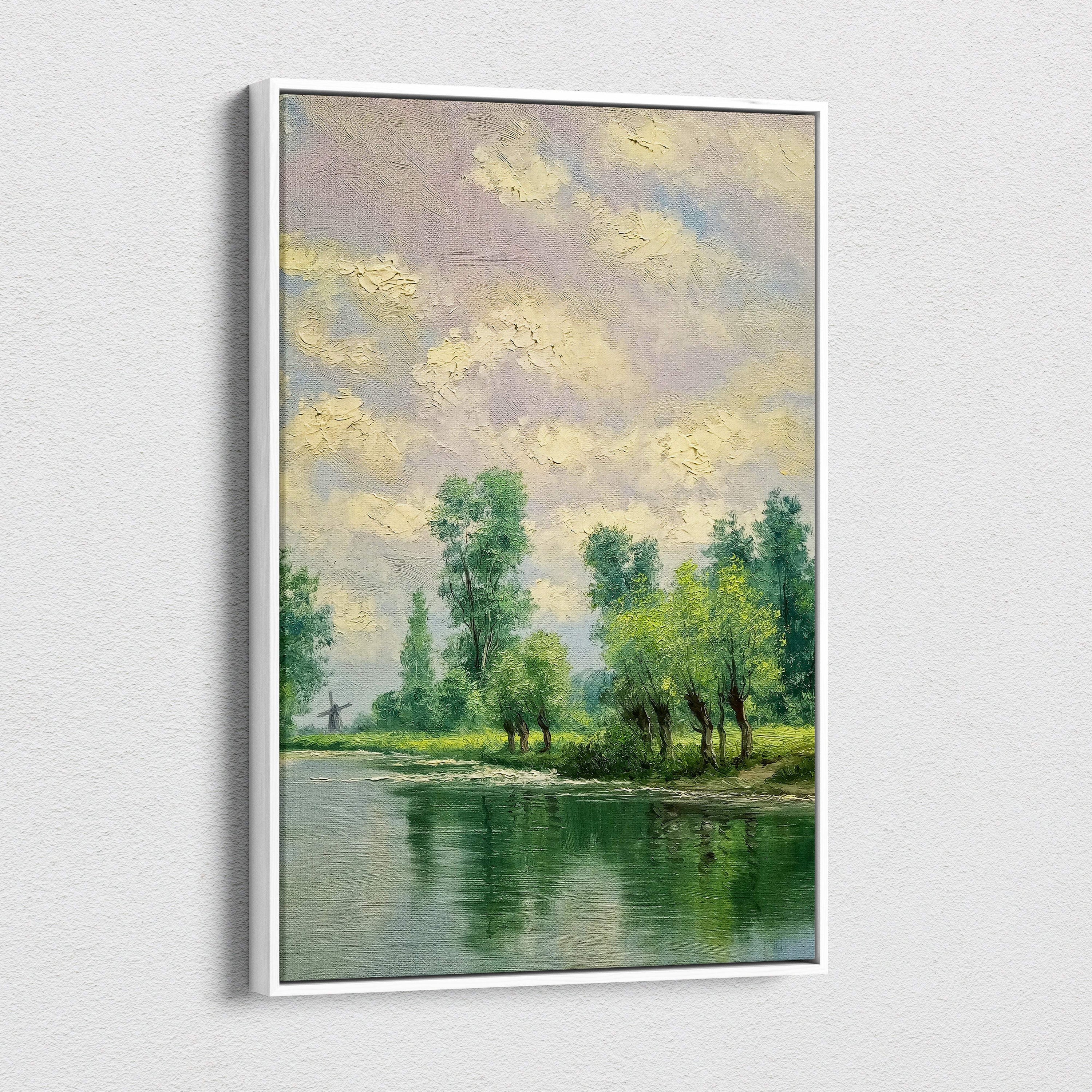 A framed impressionist canvas print of tranquil riverside landscape with lush green trees and pastel textured sky