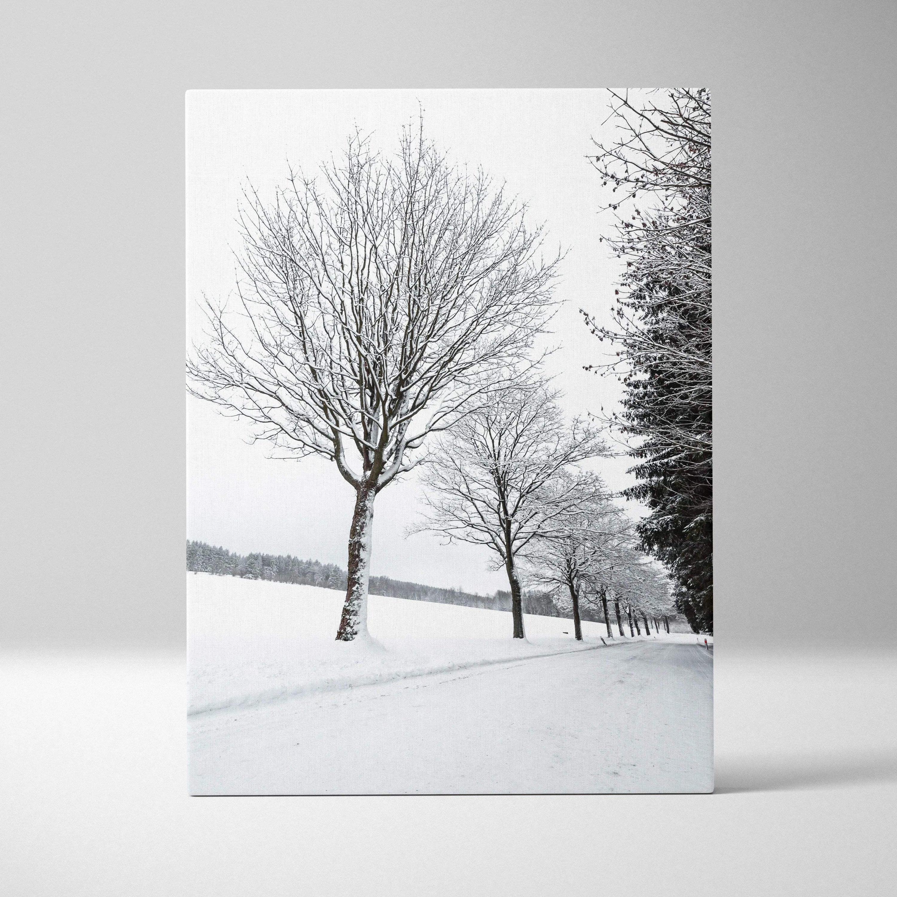Vertical canvas wall art featuring snowy trees in a winter landscape for home decor.