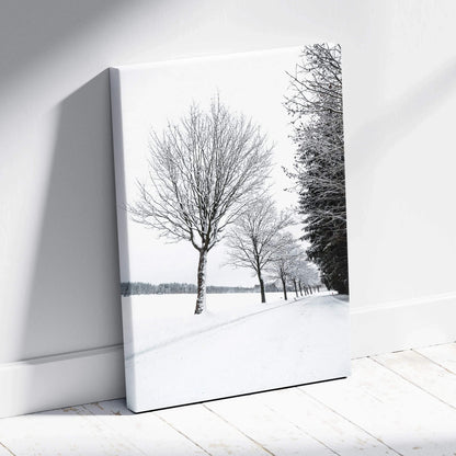 Canvas wall art featuring a serene winter scene with snow-covered trees and a peaceful snowy landscape decor.