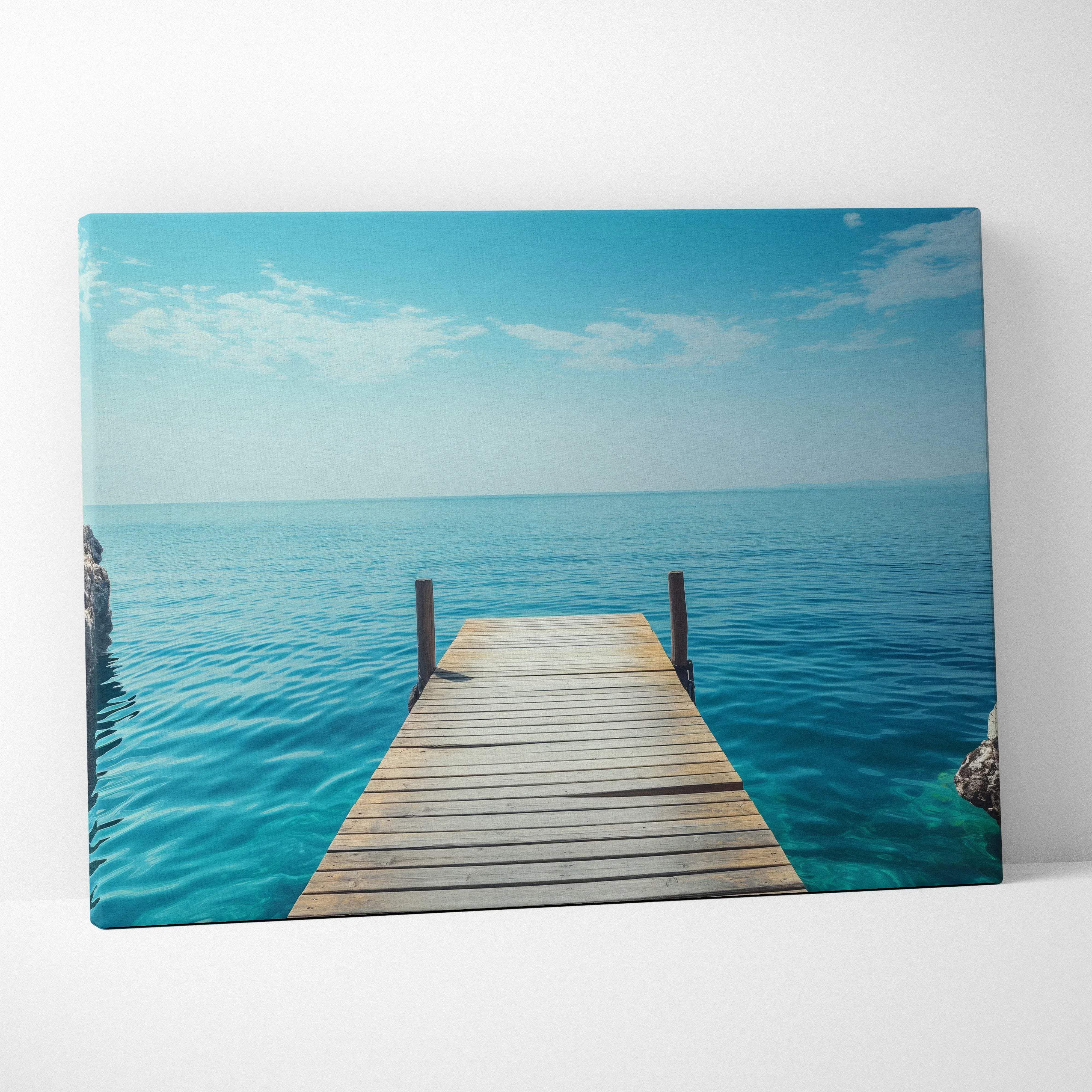 Canvas print of wooden pier over turquoise ocean under blue sky