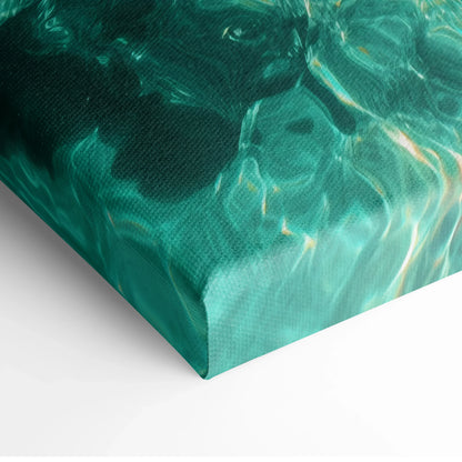 Close-up of canvas wall art featuring a teal and turquoise underwater beach scene with light reflections on water surface.