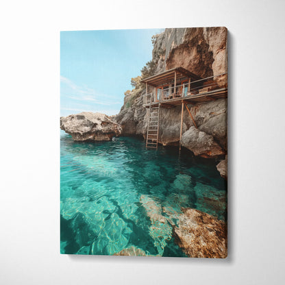 Canvas wall art featuring a serene beach scene with clear turquoise water and rocky cliffs with a wooden structure.