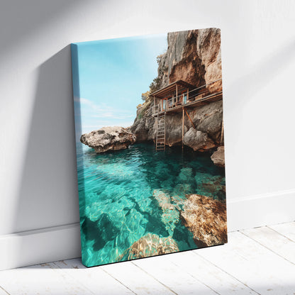 Canvas wall art featuring a serene beach scene with clear turquoise water and rocky cliffs.
