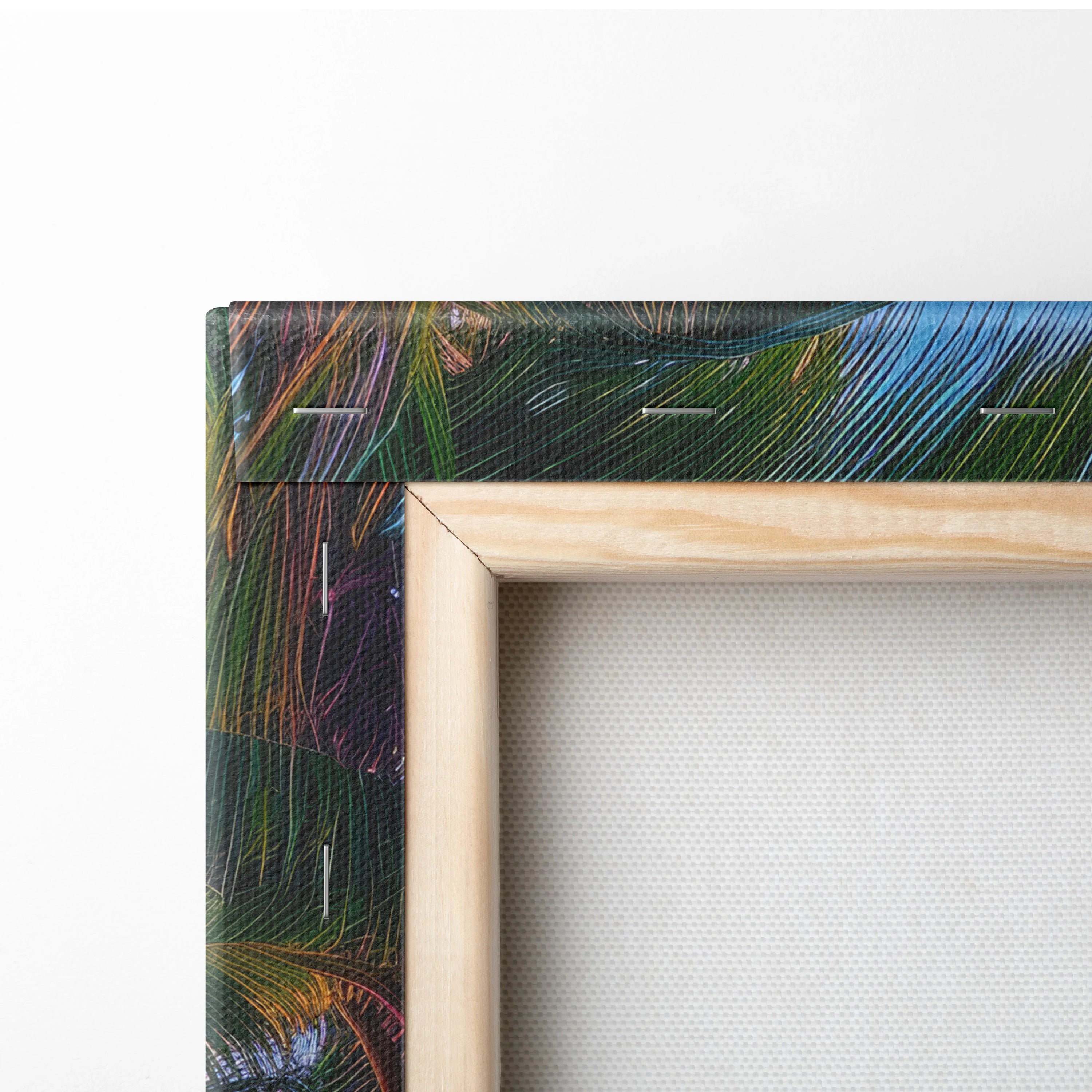 Close-up of canvas art stretched on a wooden frame with vivid tropical leaf print on edges.