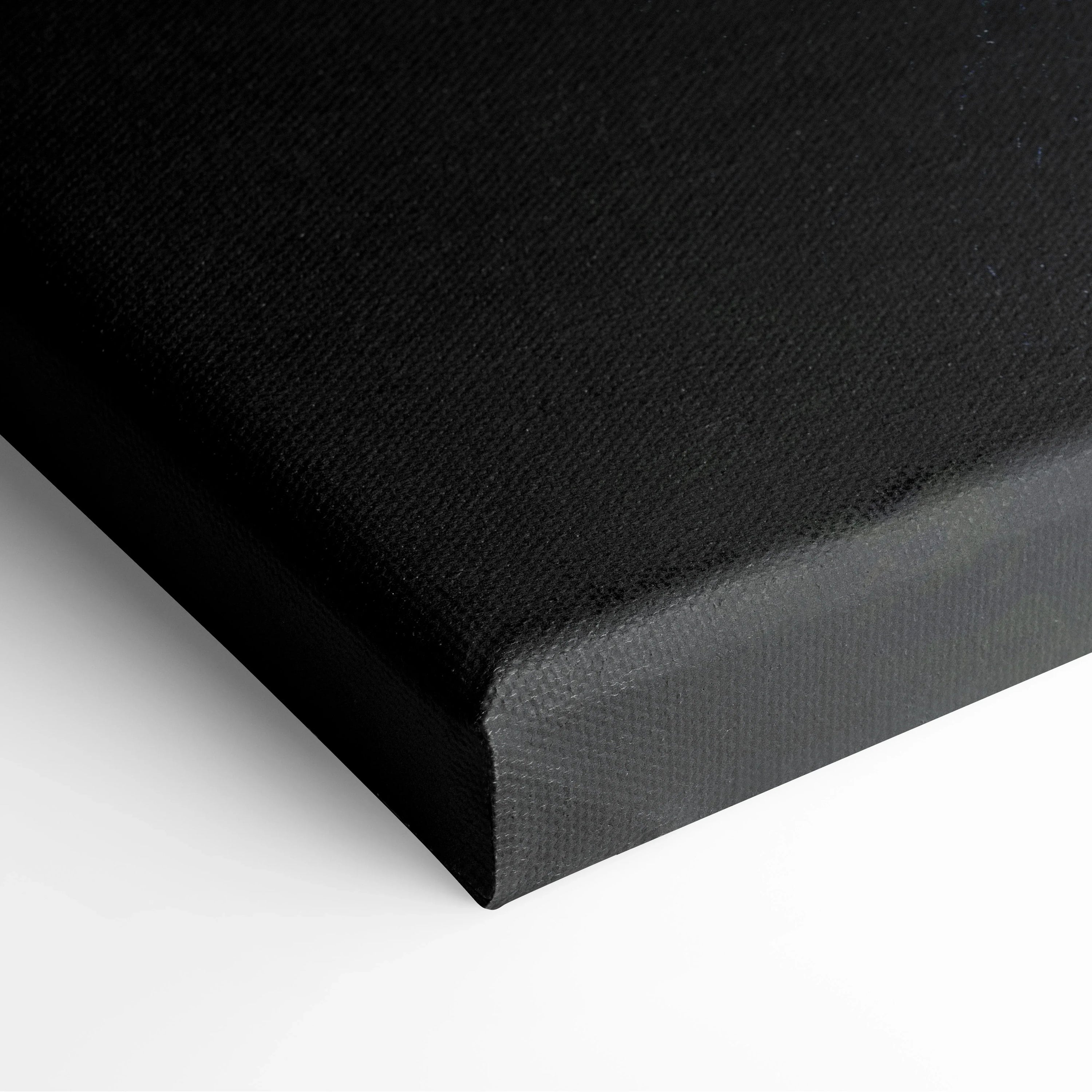 Close-up of black stretched canvas corner with textured surface and clean edges for wall art decor.
