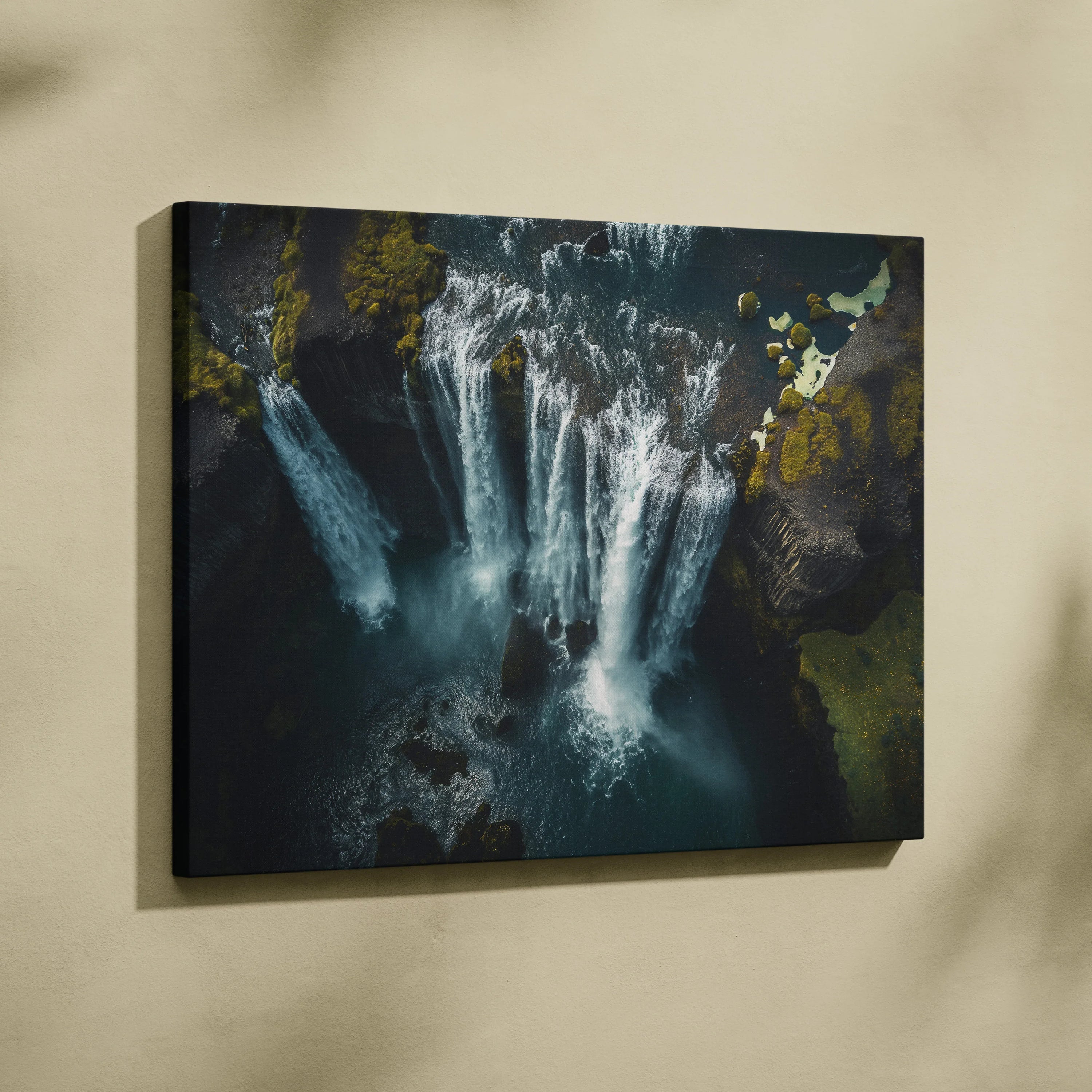 Iceland waterfall canvas wall art with high-resolution nature scene in dark, moody tones for decor.