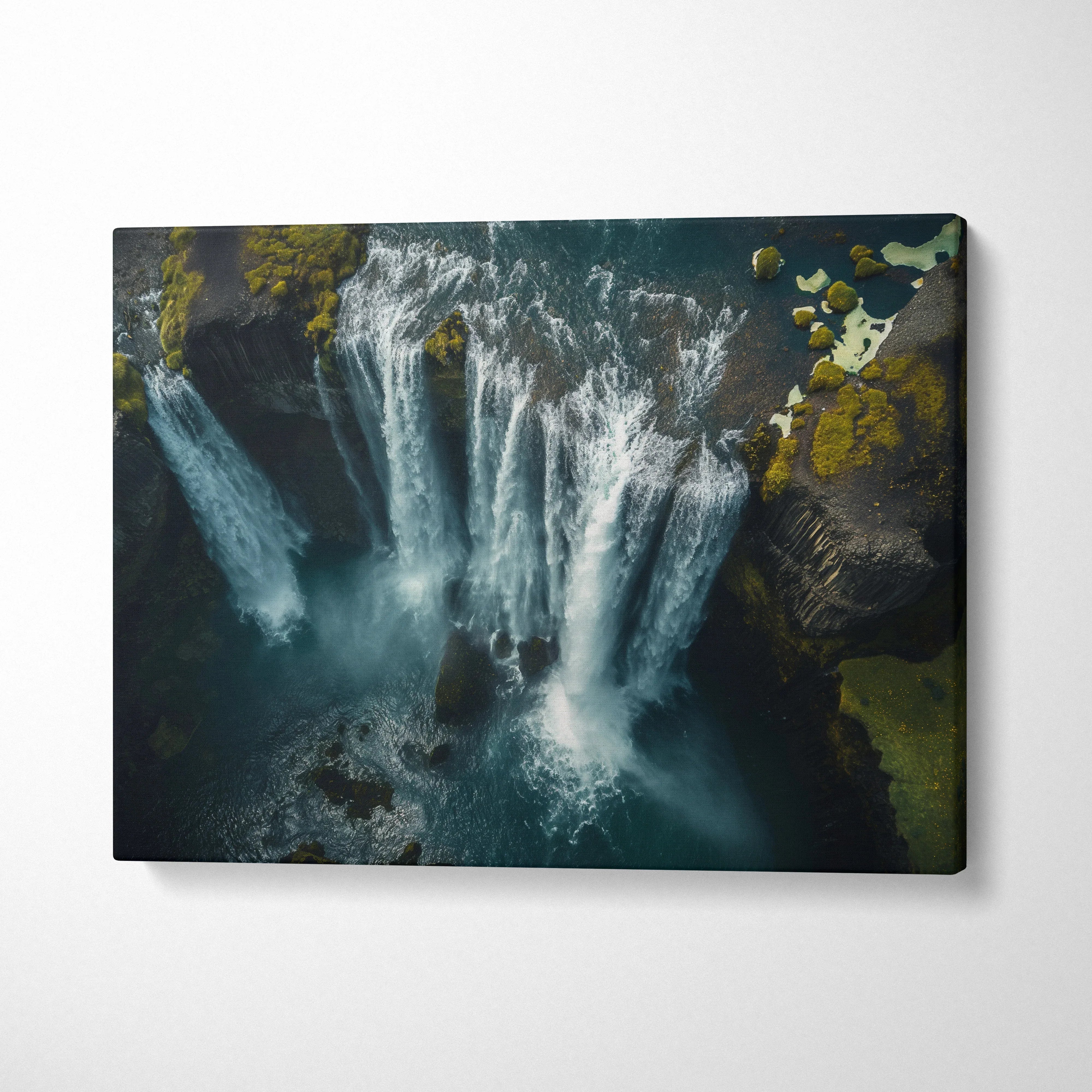 Iceland waterfall canvas wall art showing high-resolution nature scene with cascading water and mossy rocks.