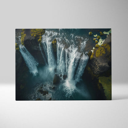 Canvas wall art featuring a high-resolution aerial view of a multi-tiered Icelandic waterfall surrounded by dark rocky.