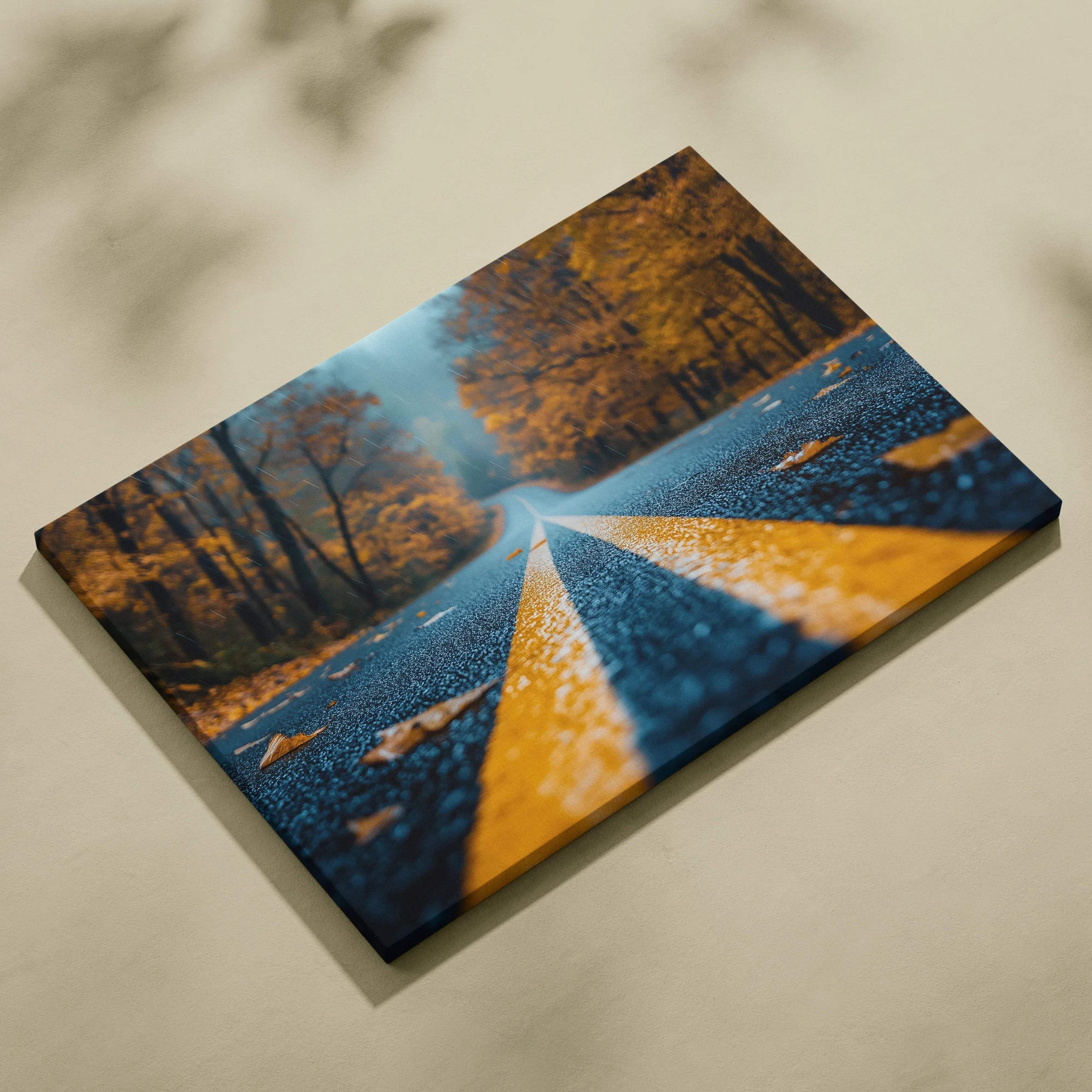 Canvas wall art featuring vibrant red and orange autumn foliage along a forest road with yellow dividing lines.