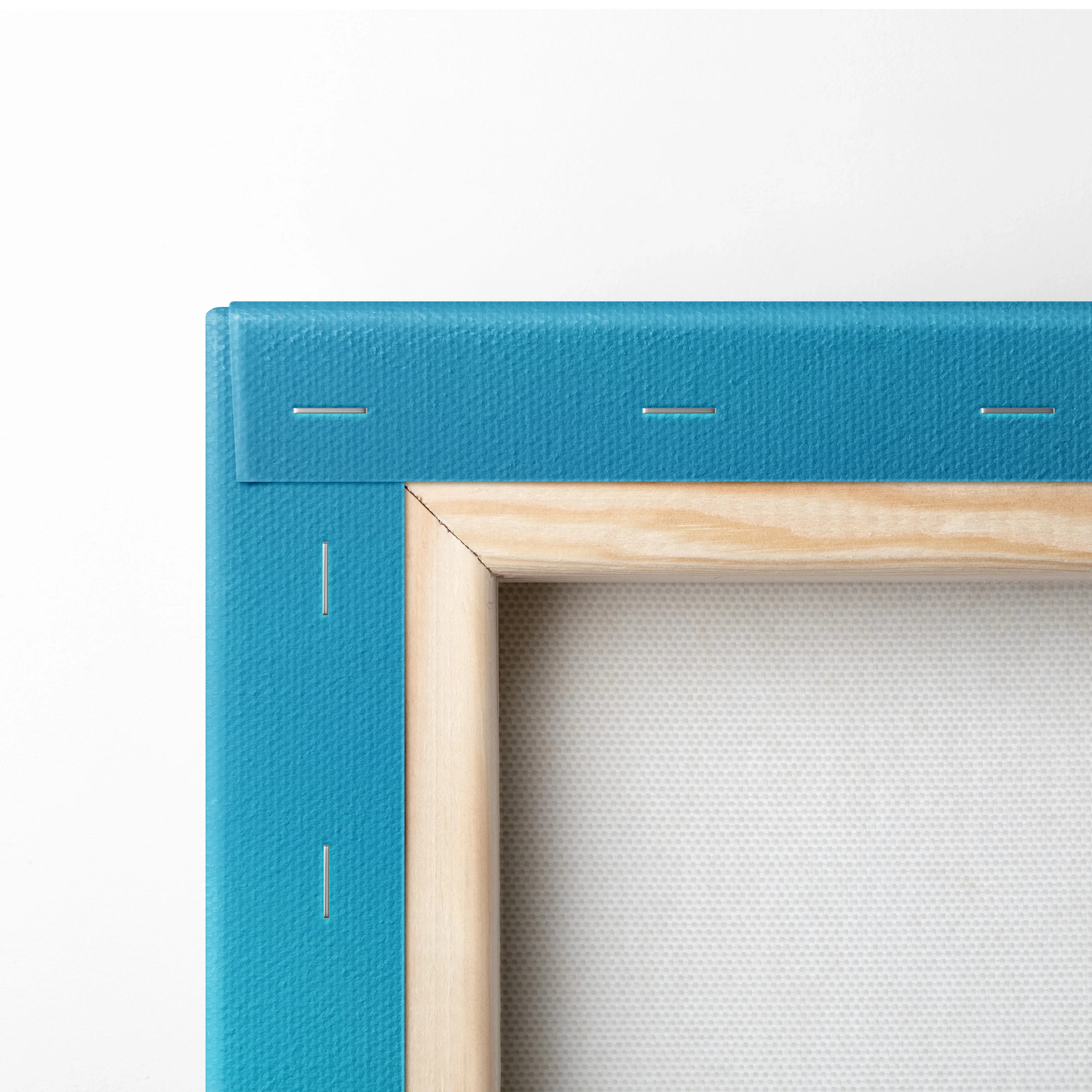 Close-up of stretched blue canvas with wooden stretcher bars and staples for wall art display.