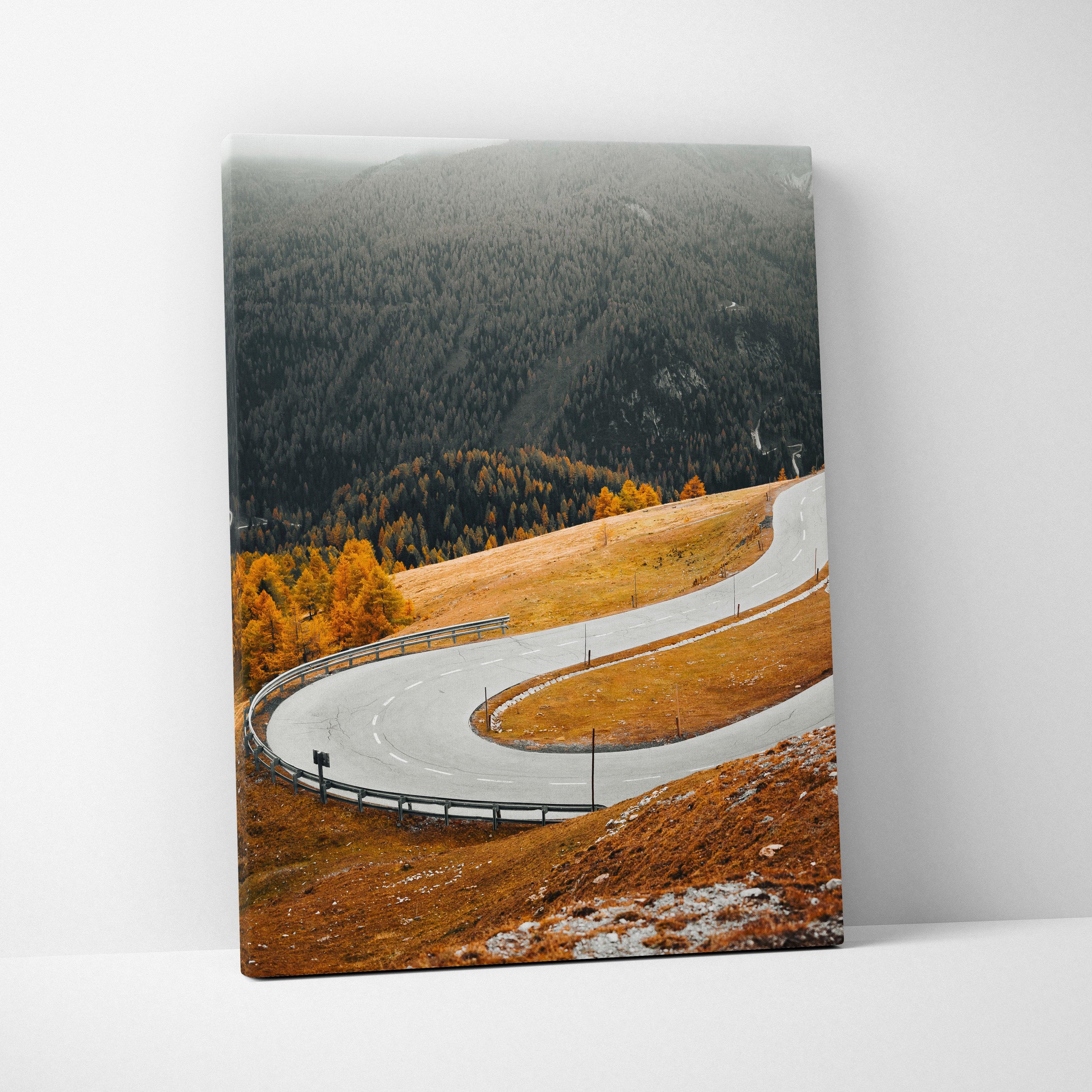 Vertical canvas art of a winding autumn road with vibrant orange trees and hills, wall art print.