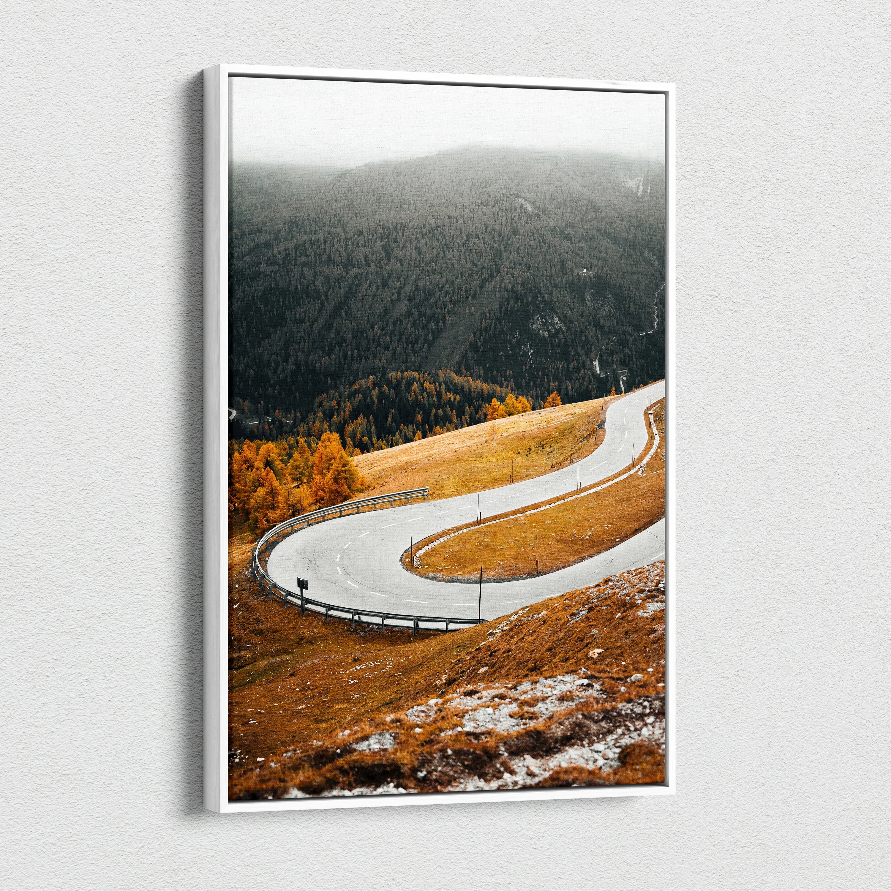 Vertical canvas art featuring a winding road through vibrant autumn landscape and misty forest wall art.