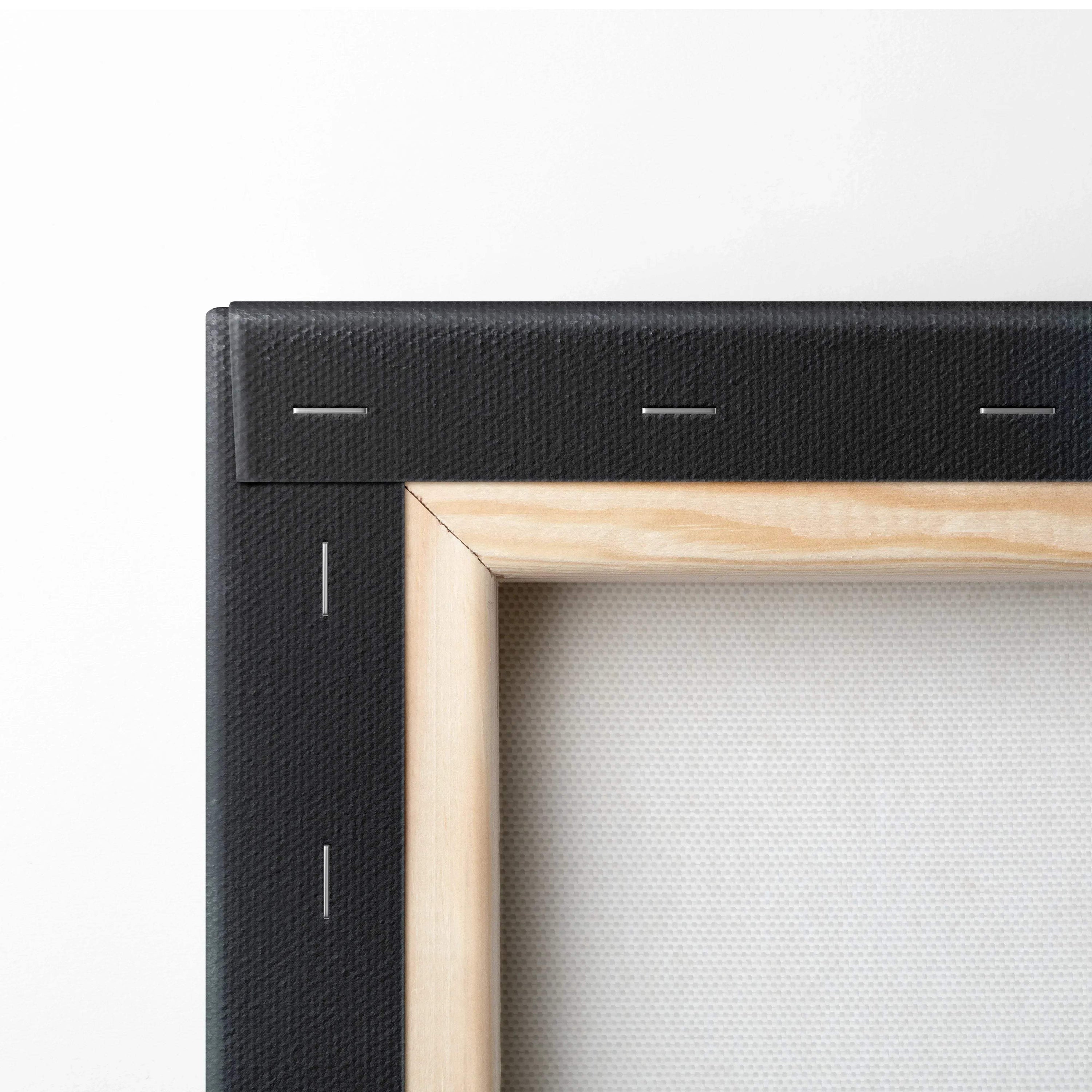 Close-up of wooden canvas stretcher frame with black edges and white canvas for wall art.
