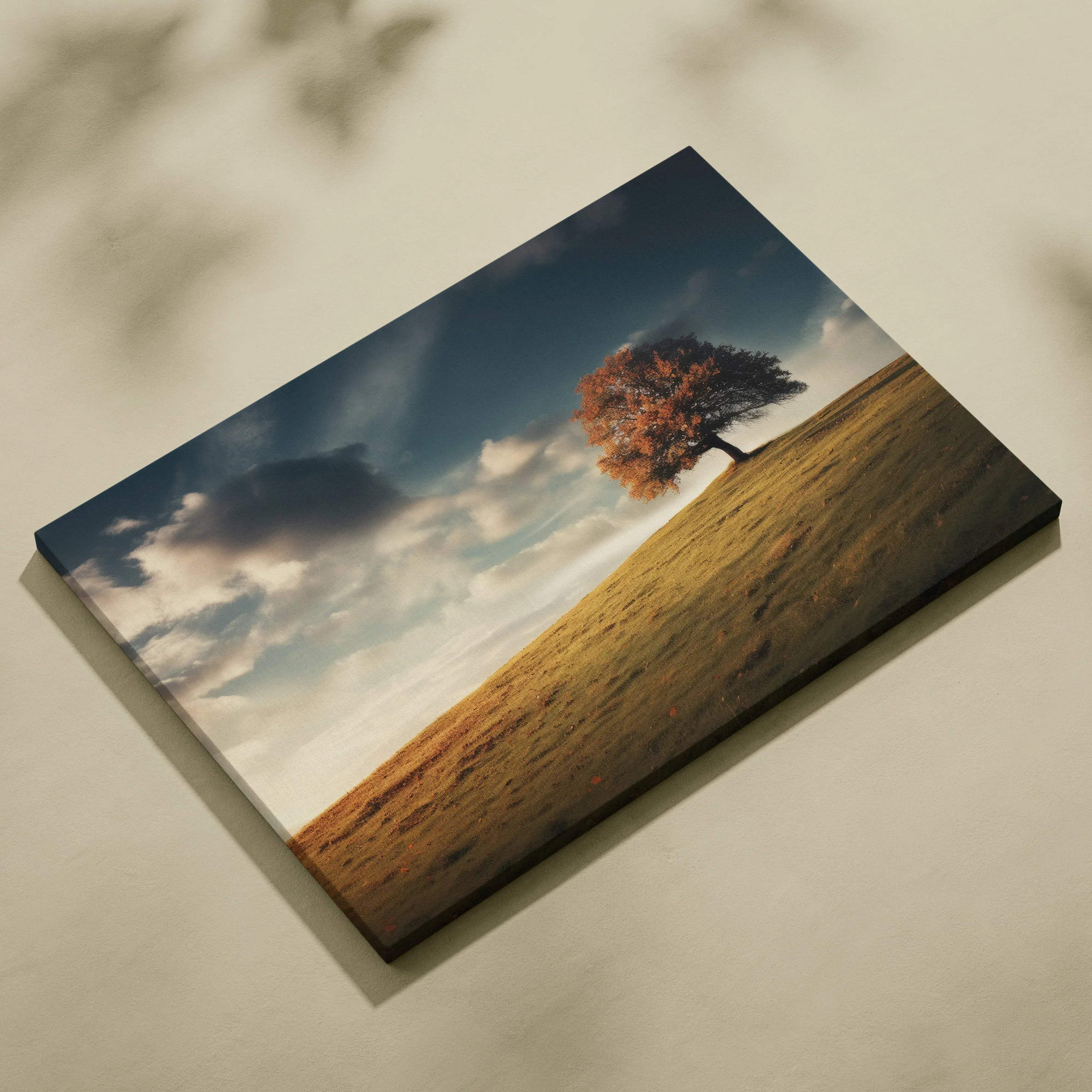 Canvas art of a lone autumn tree with vibrant orange leaves on a grassy hill under a cloudy sky, wall art.