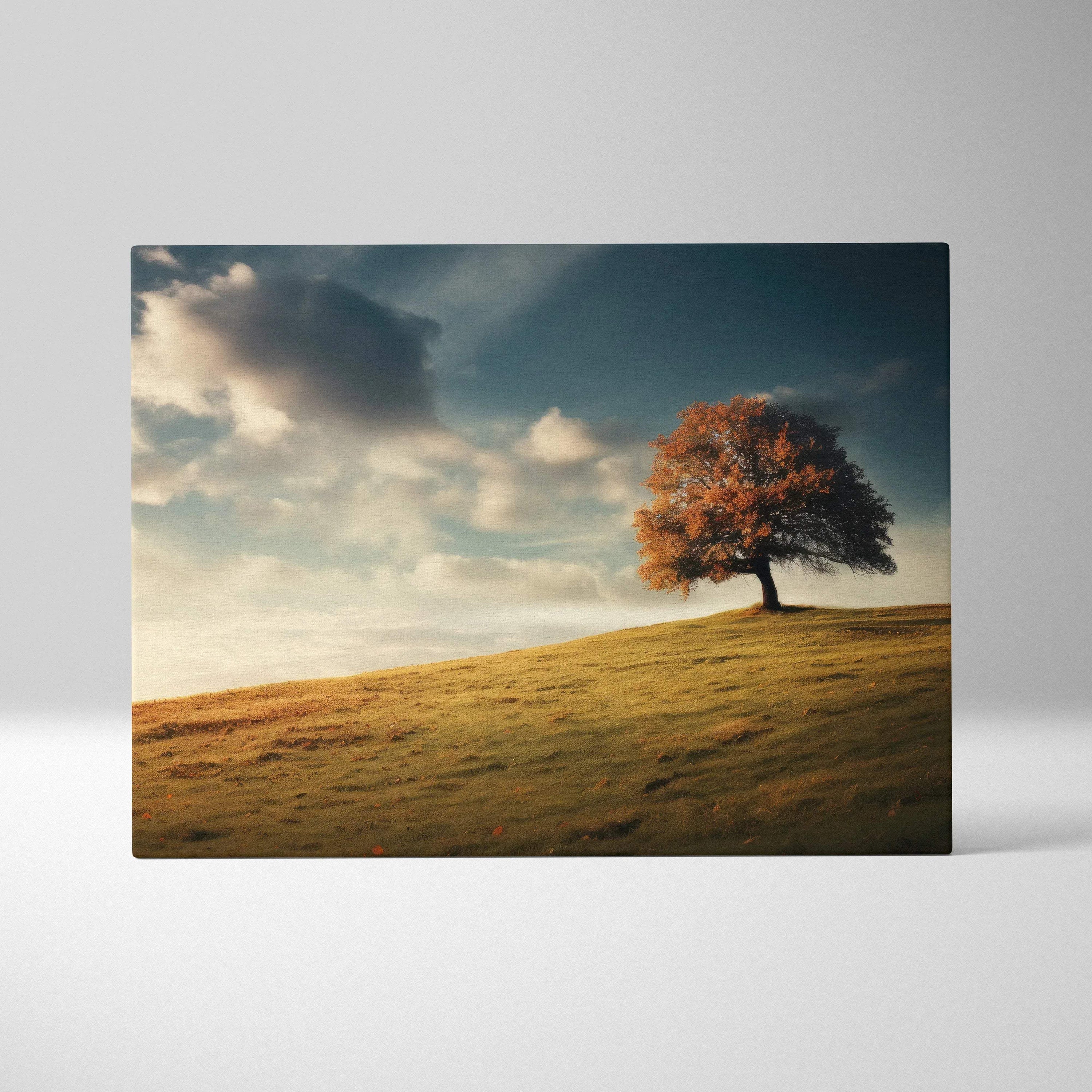 Autumn tree with vibrant orange leaves on grassy hill under cloudy sky canvas wall art.