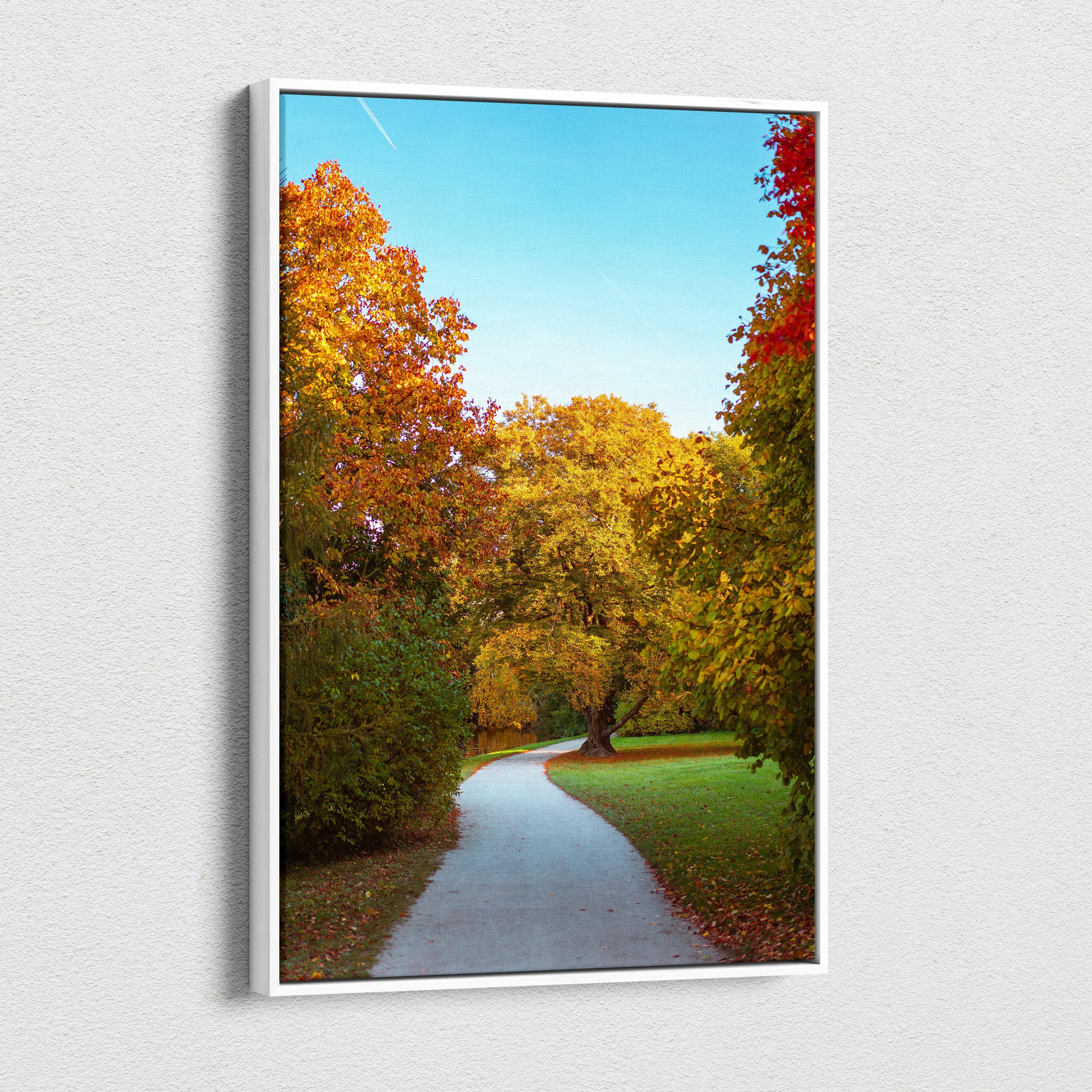 Vibrant autumn landscape canvas art showing a winding path through colorful fall trees under a clear blue sky.