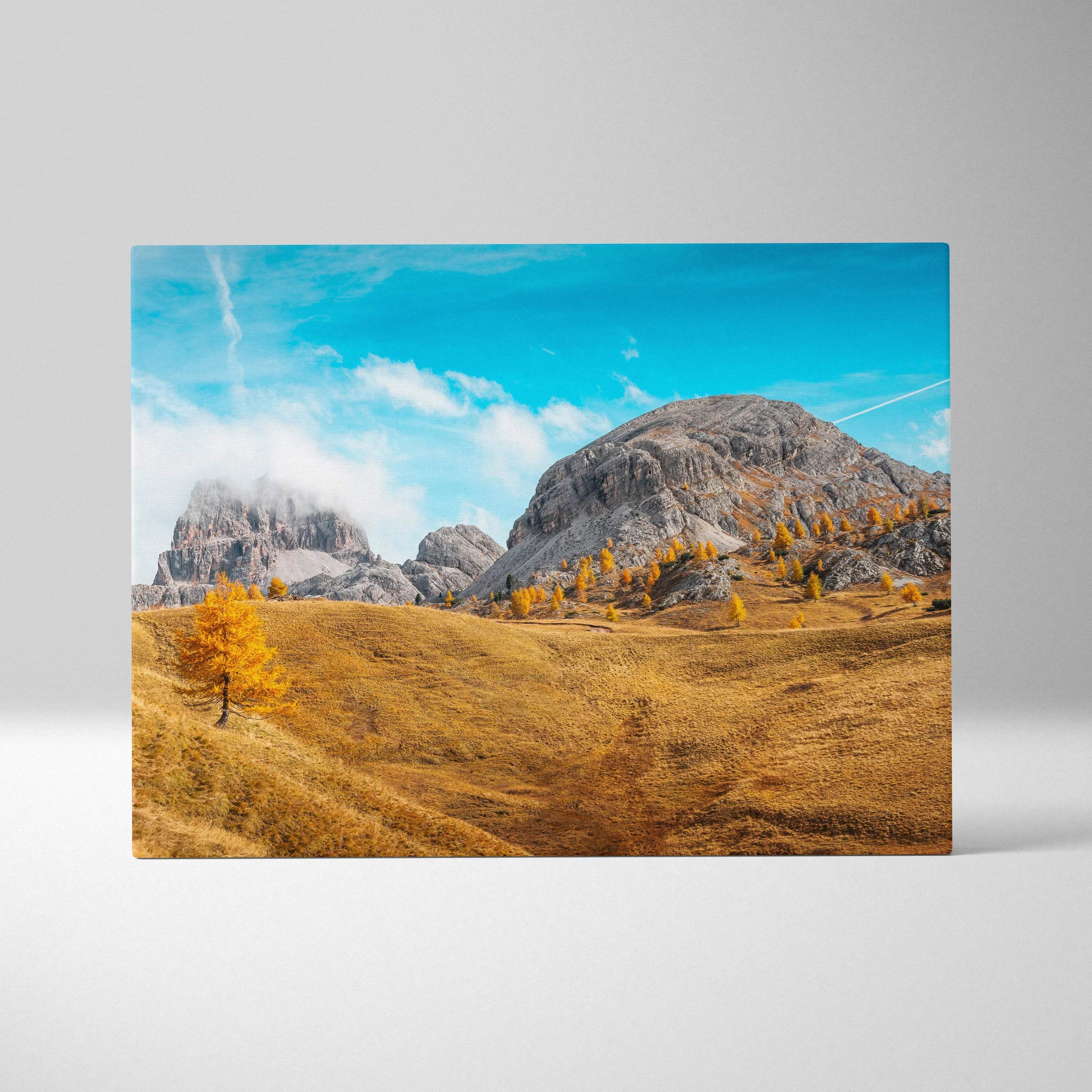 Canvas wall art featuring golden autumn trees and rugged mountain landscape under bright blue sky.