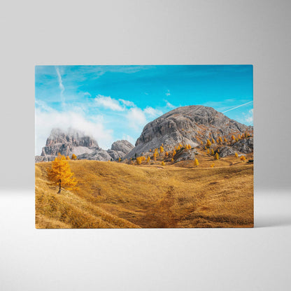 Canvas wall art featuring golden autumn trees and rugged mountain landscape under bright blue sky.