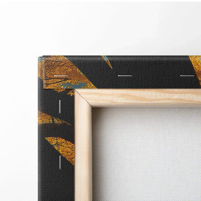 Close-up of wooden frame corner on canvas art with autumn leaves design and black background.