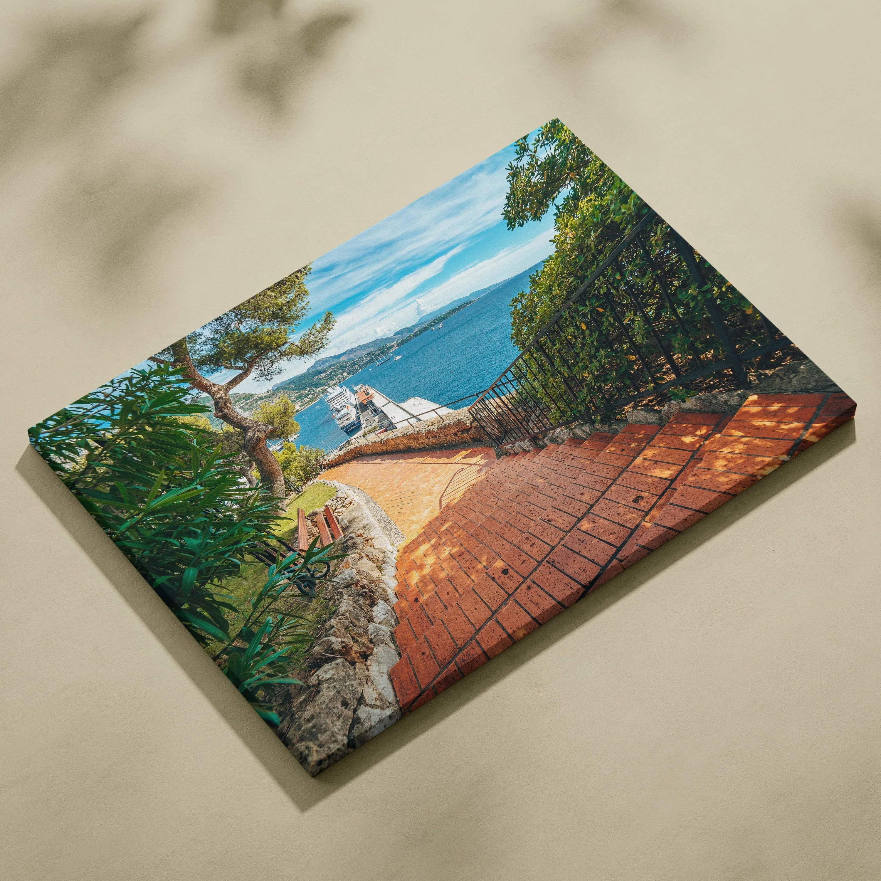 Canvas wall art print featuring a vibrant coastal walkway with greenery and blue sky in digital art style.