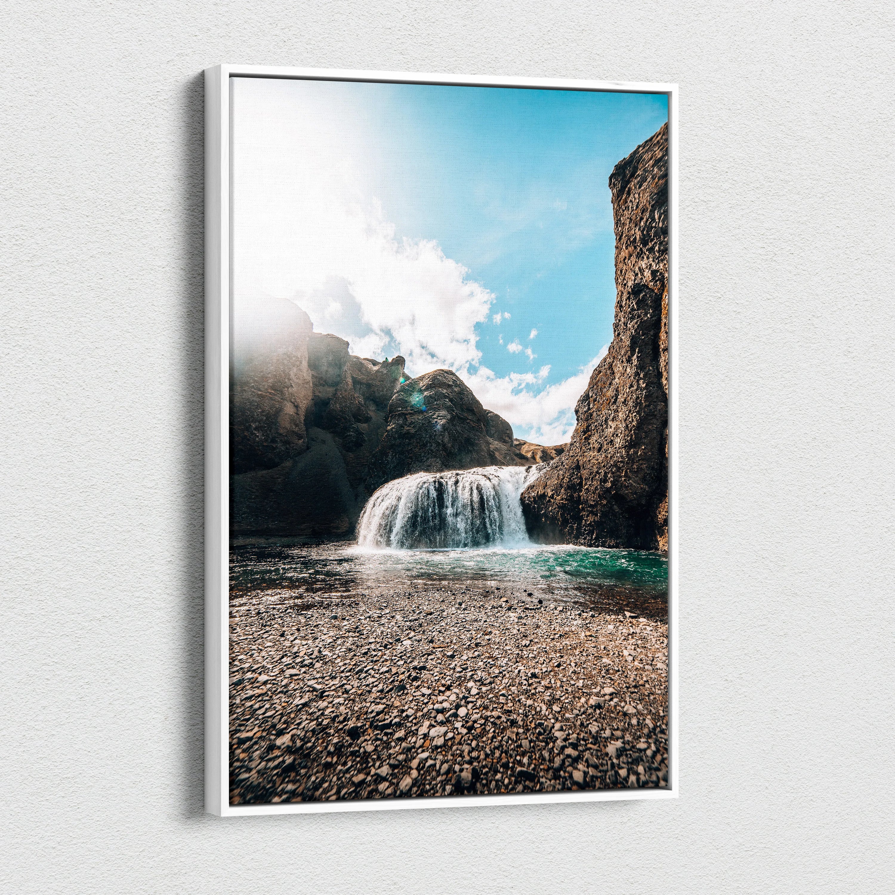Canvas wall art featuring a high-resolution Iceland waterfall with rocky cliffs and bright blue sky decor.