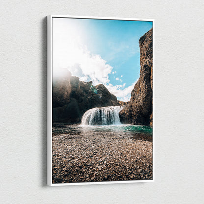 Canvas wall art featuring a high-resolution Iceland waterfall with rocky cliffs and bright blue sky decor.