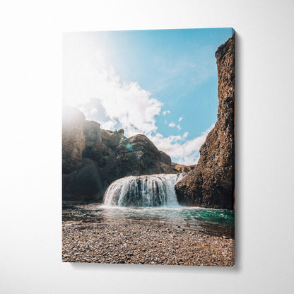 Vertical canvas wall art featuring a bright Iceland waterfall landscape with blue sky and rocky cliffs decor.