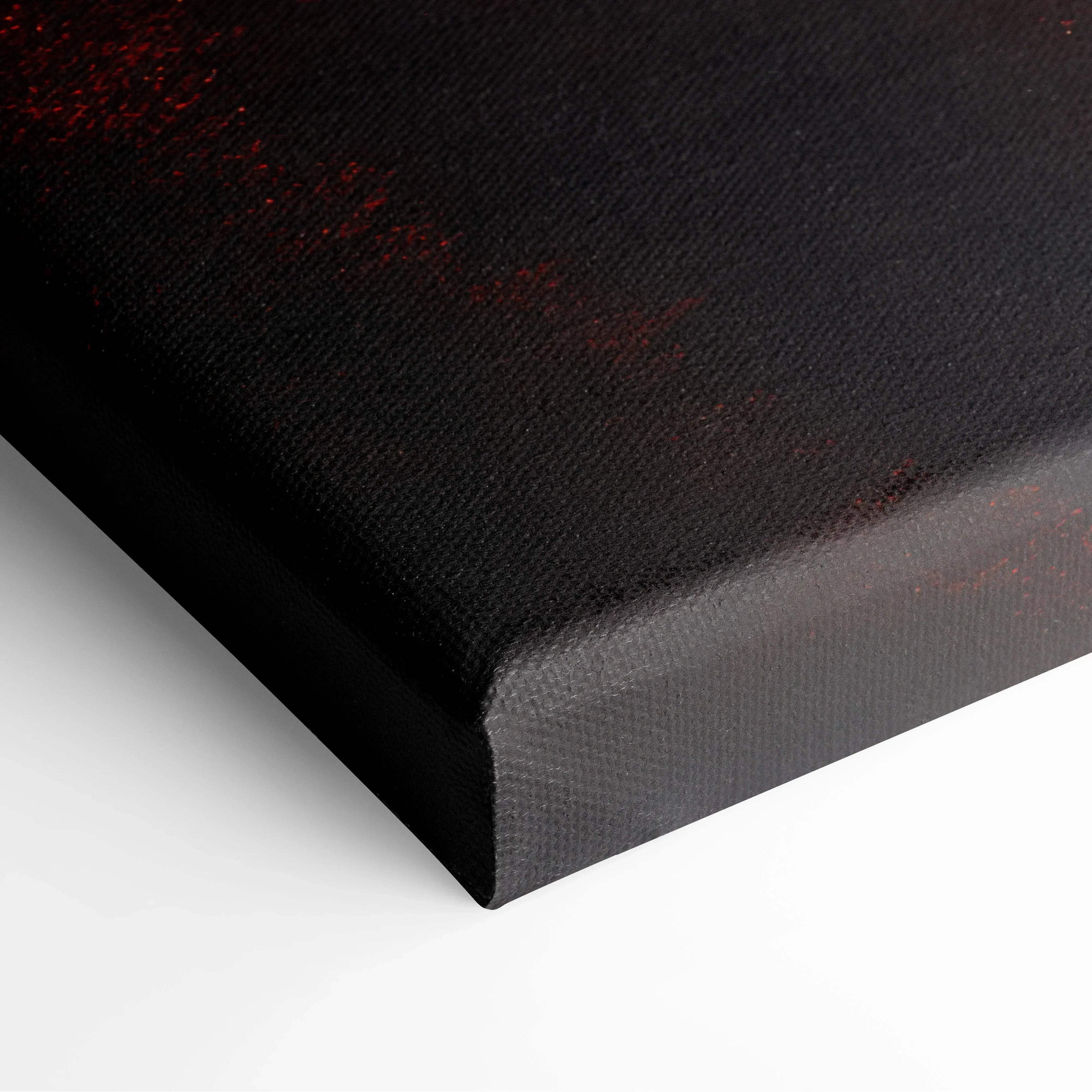Close-up of black edge on canvas art with red and dark tones in wall art print texture.