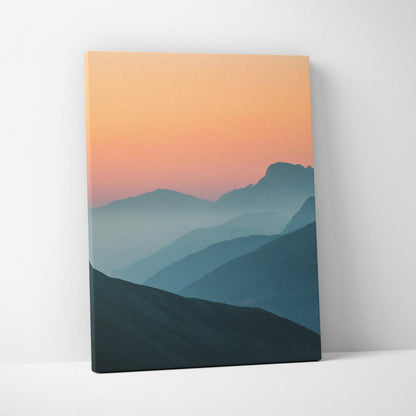 Canvas wall art of serene minimal mountain sunset peaks over layered blues peach sky