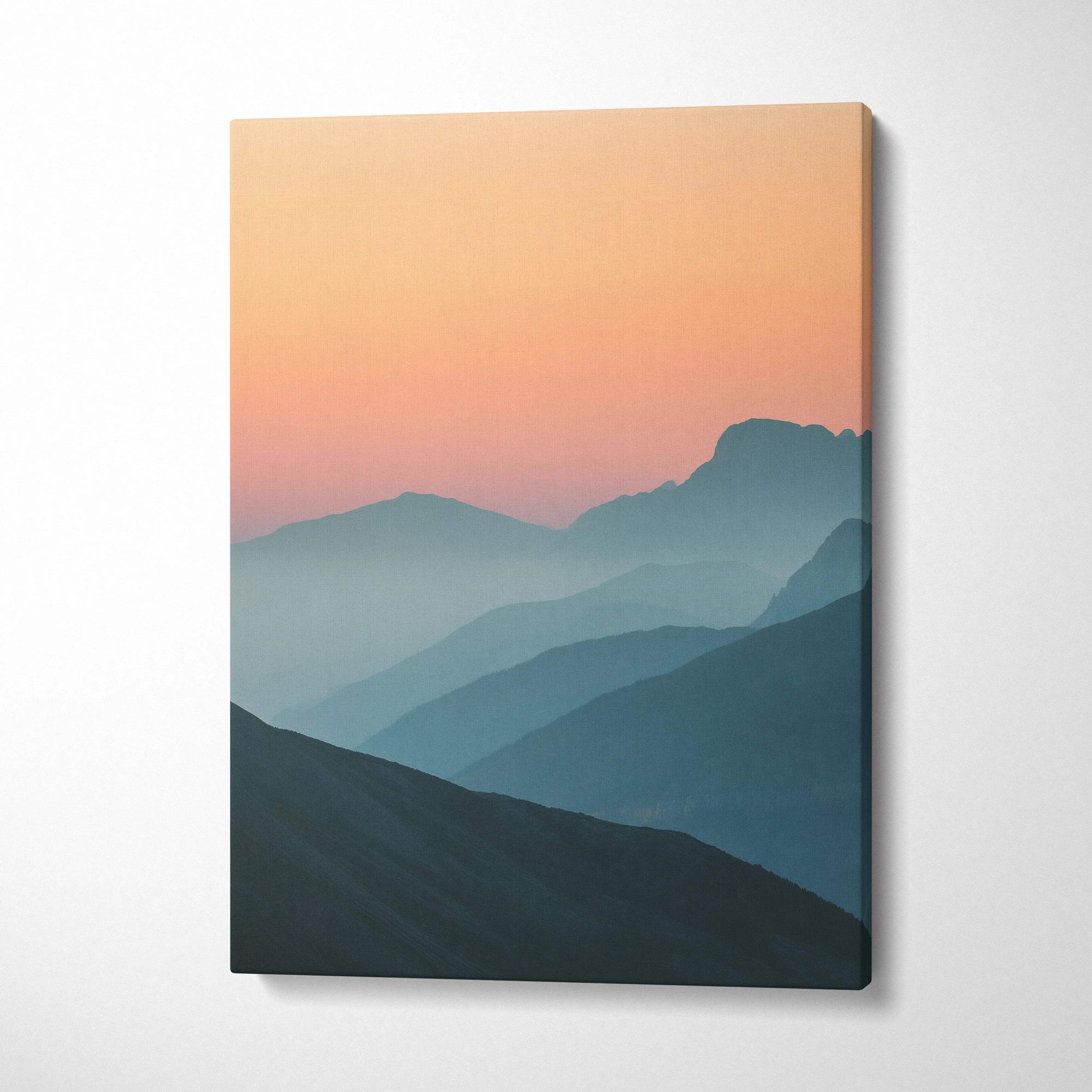 Canvas wall art: minimal mountain sunset peaks over layered blues peach sky