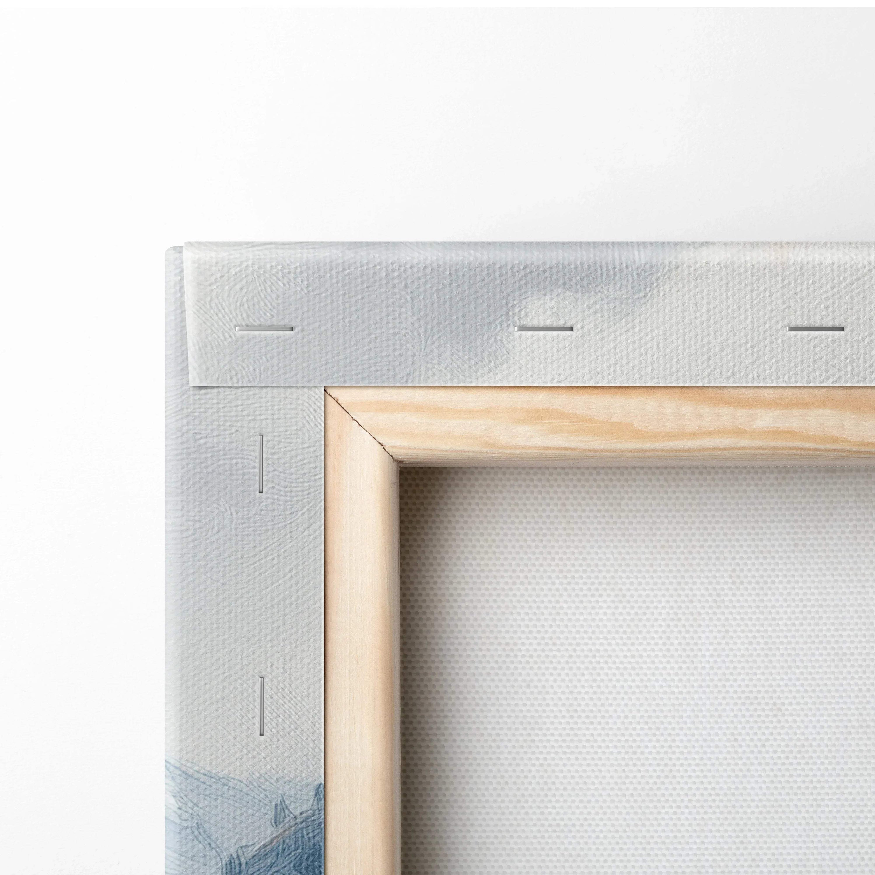 Close-up of stretched canvas art corner with wooden frame and visible mountain print on wall art.