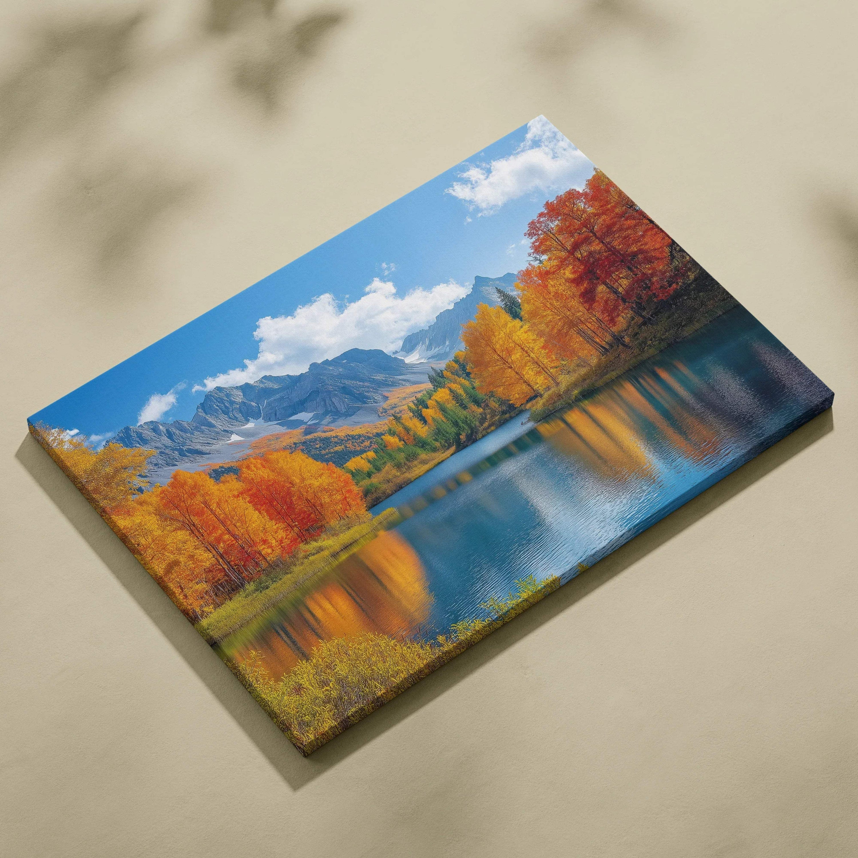 Horizontal canvas art wall print of vibrant autumn trees by a mountain lake under a blue sky.
