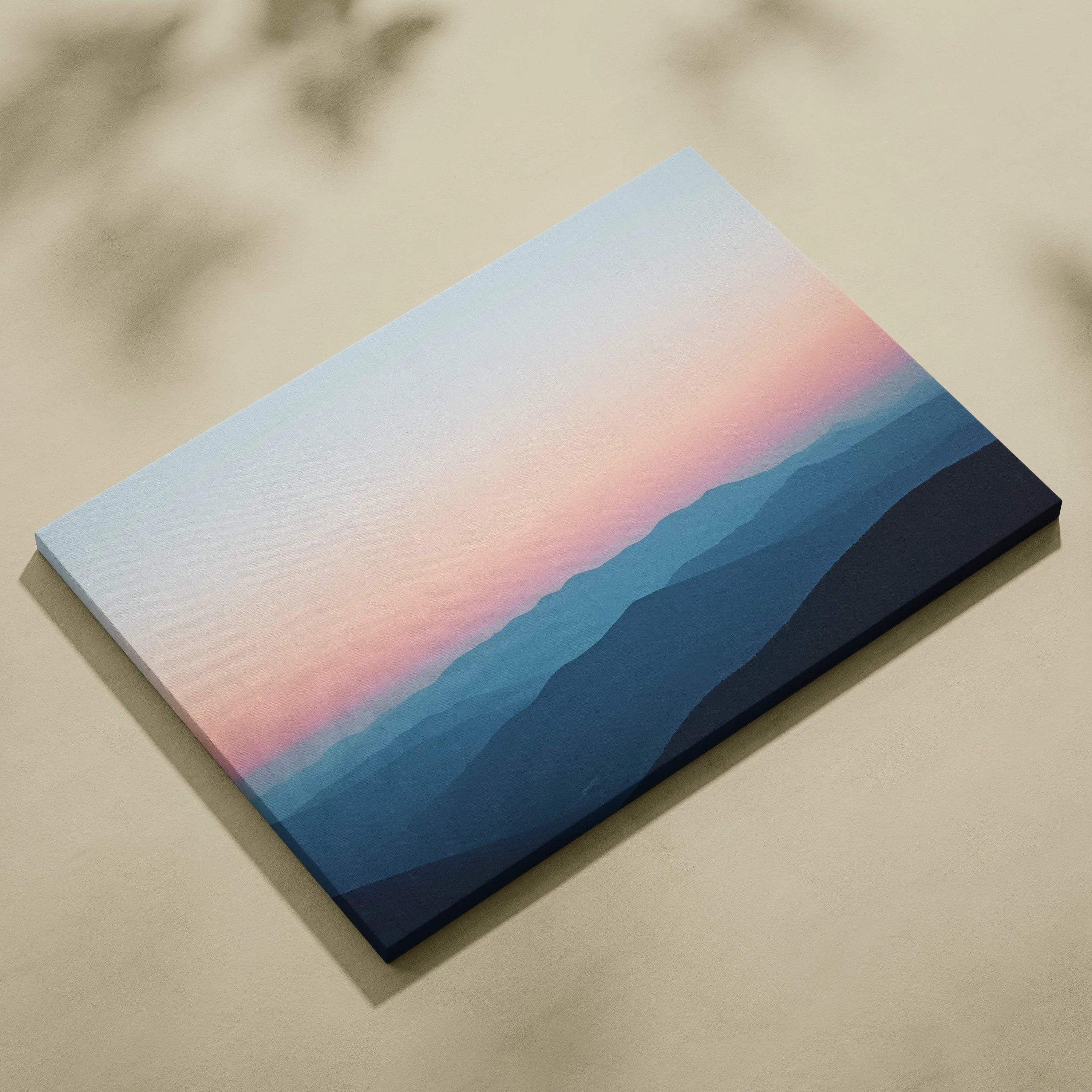 Canvas print of serene sunrise over mountains in calm pastel sky blues and pink