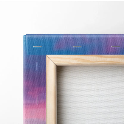 Close-up of a stretched canvas art with wooden frame and purple-pink sunset beach design wrapping around the edge.