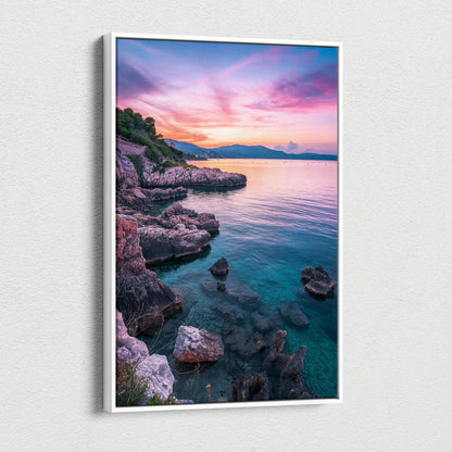 Canvas wall art depicting a rocky beach at sunset with vibrant pink and purple sky over calm blue water.