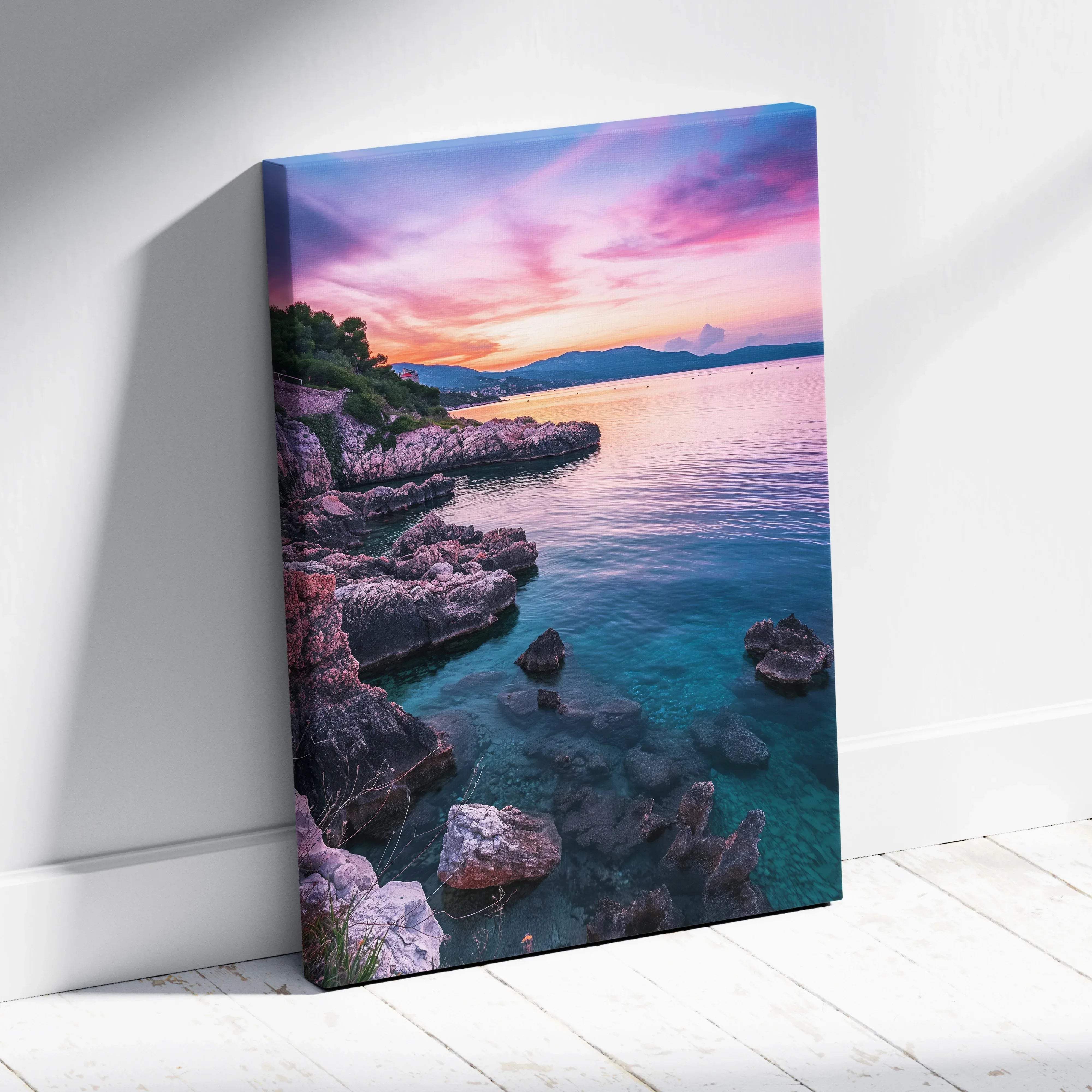 Coastal sunset landscape canvas wall art featuring turquoise sea, rugged rocks, and pastel pink and purple sky hues