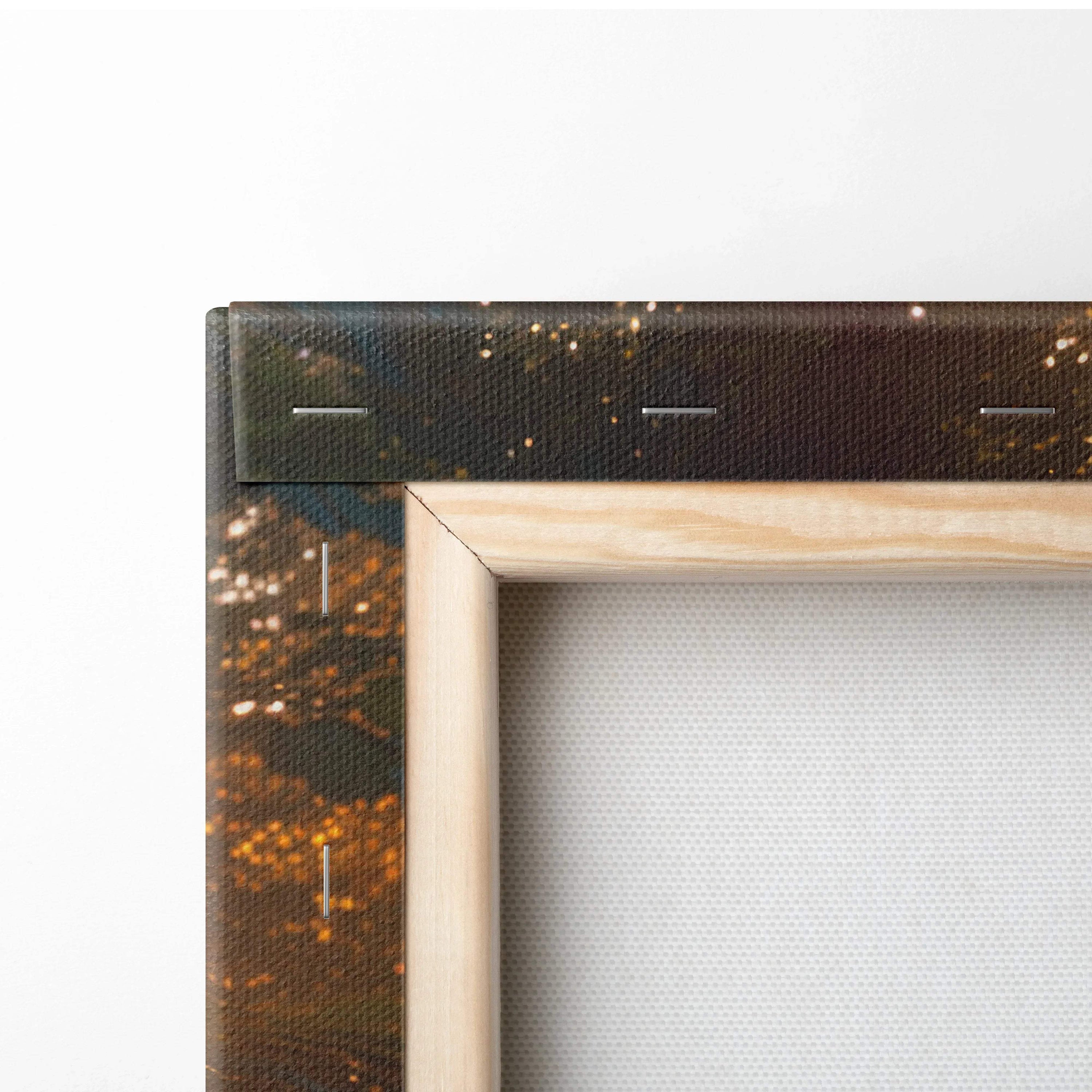 Close-up of forest sunset canvas wall art corner with wooden frame and golden tree hues decor.