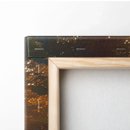 Close-up of forest sunset canvas wall art corner with wooden frame and golden tree hues decor.