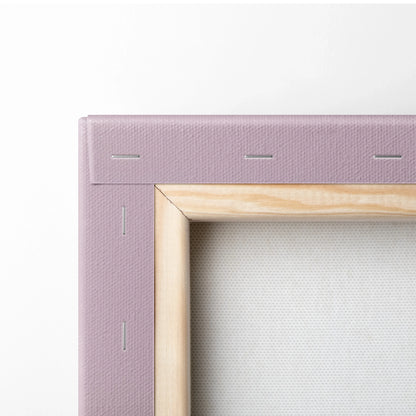 Close-up of wooden-framed canvas with pink fabric stapled around edges for wall art decor.