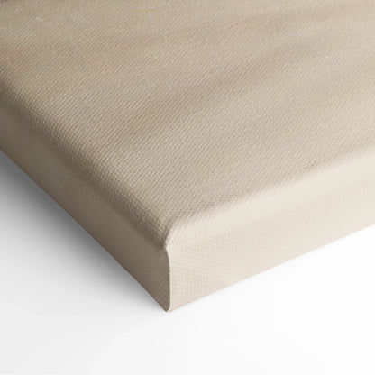 Close-up of beige canvas wall art with textured fabric and neatly wrapped edges.