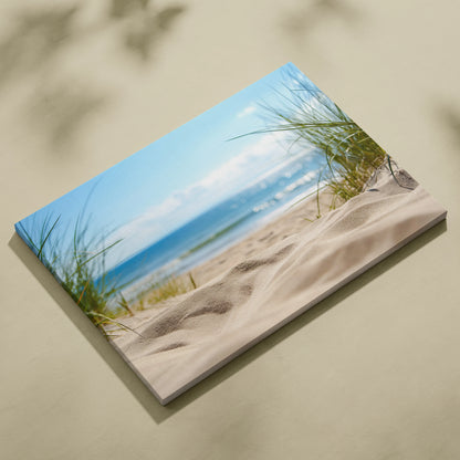Canvas wall art featuring sandy beach dunes with green grass and calm ocean waves under a blue sky.