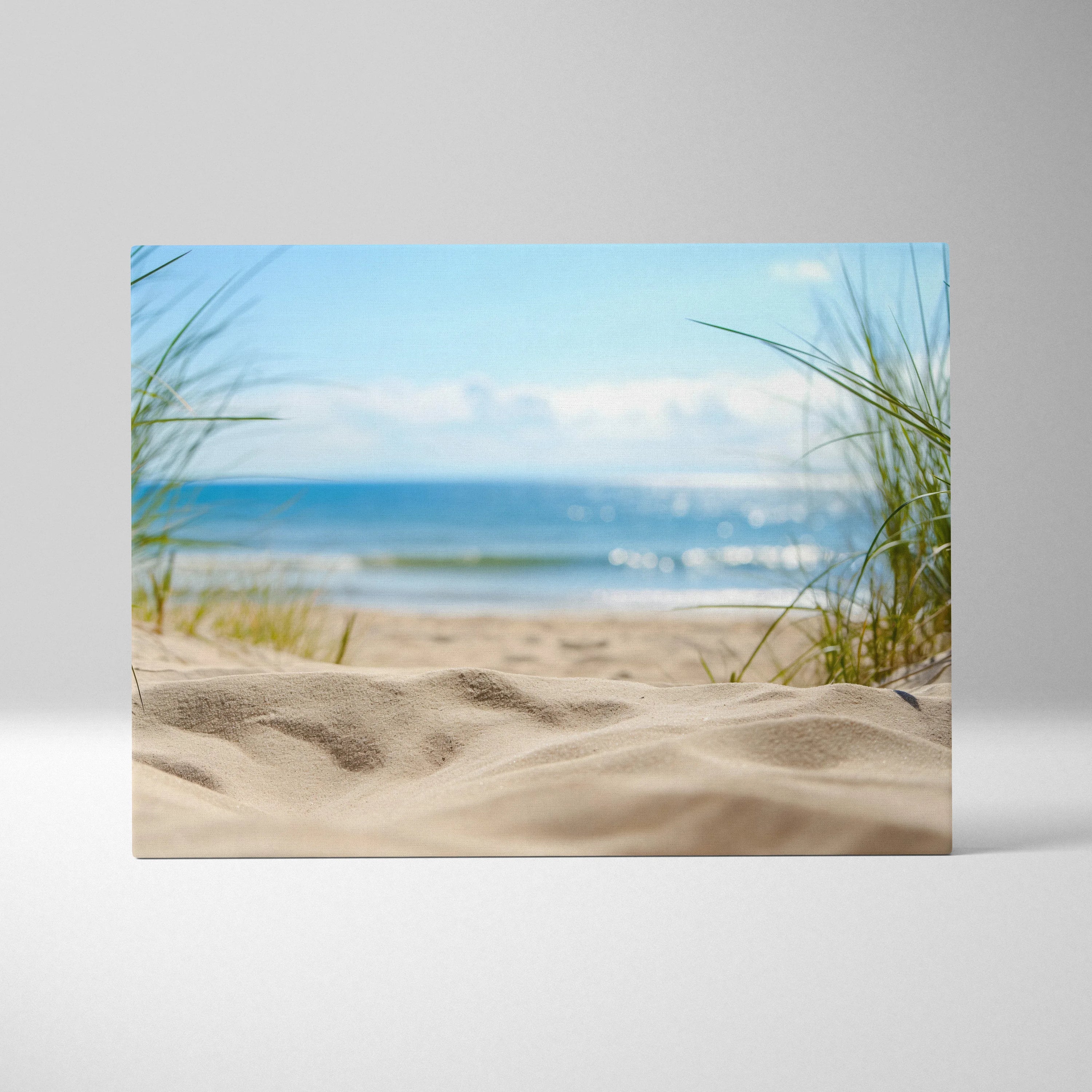 Canvas wall art featuring soft sandy beach, tall dune grass, blue ocean waves, and clear sky with clouds.