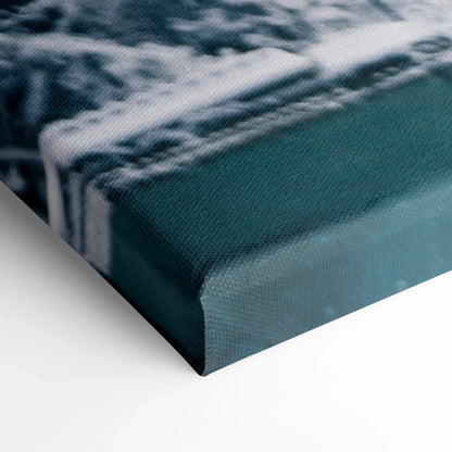 Close-up of canvas wall art corner featuring a snowy branch design with textured fabric and deep green background color.