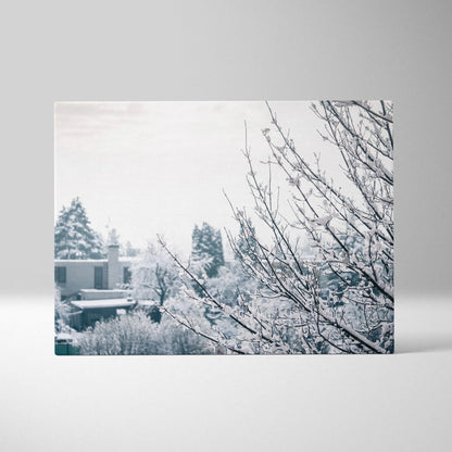 Canvas wall art featuring delicate snow-covered branches in a soft, muted winter landscape decor.