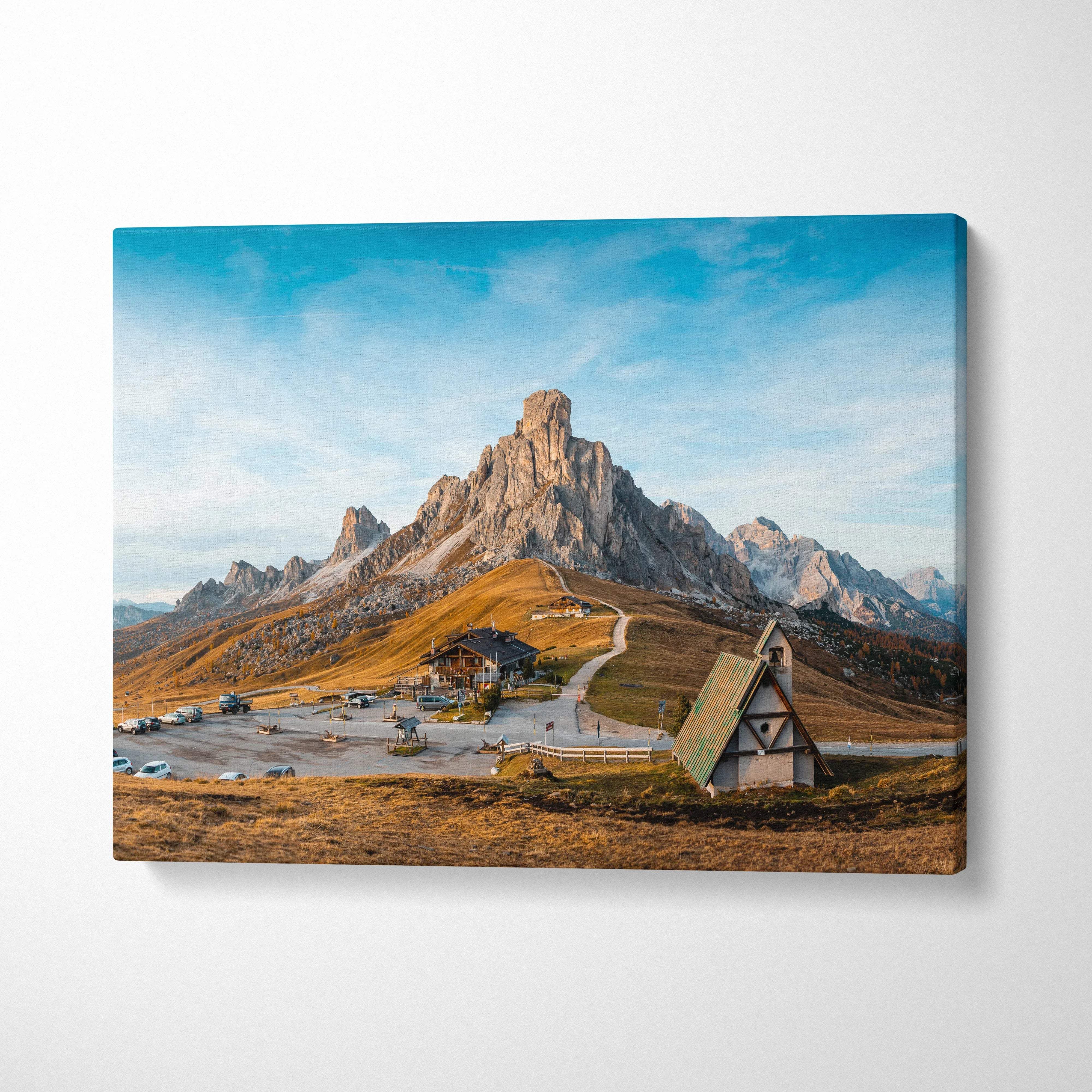 Canvas print of Dolomite Peaks, Giau Pass church in golden hour valley