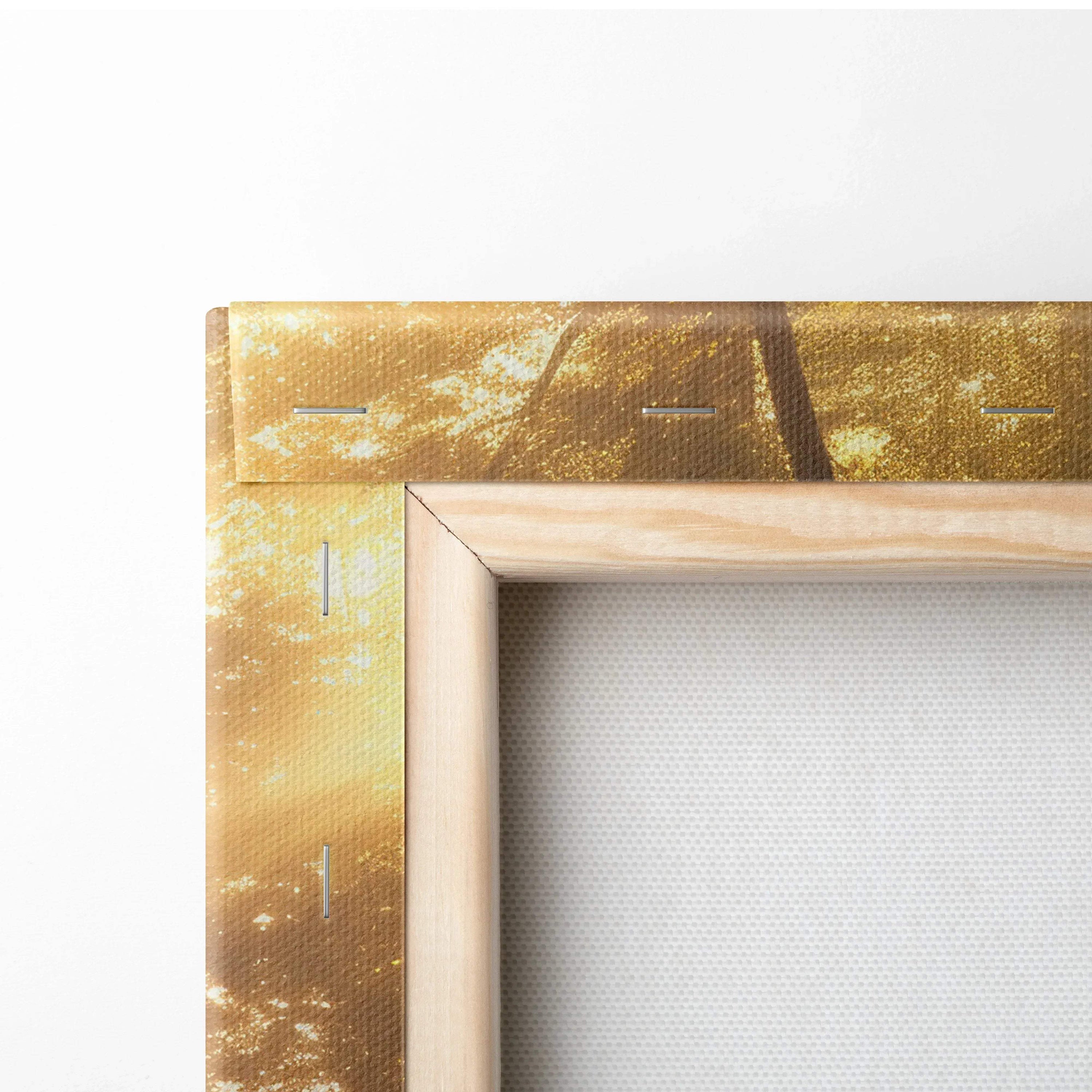 Close-up of stretched canvas wall art with wooden frame featuring golden forest sunset landscape decor.