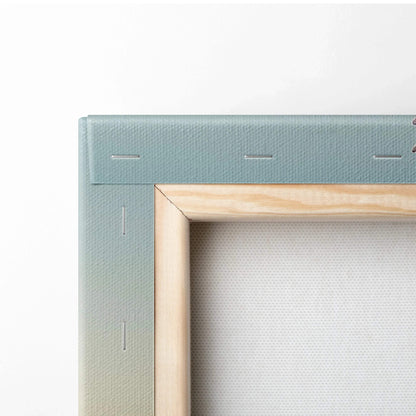 Close-up of light wood stretcher frame holding tightly stretched blue canvas fabric for wall art decor.