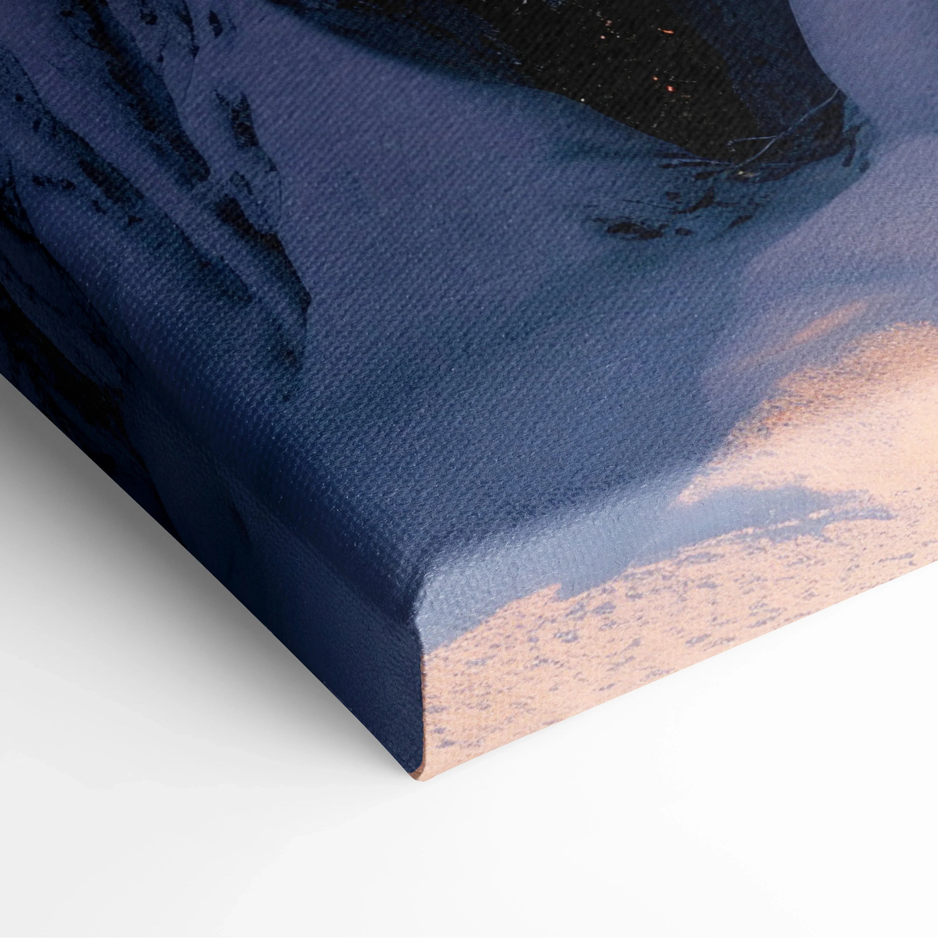 Close-up of canvas wall art showing textured snowy mountain sunset detail in winter landscape decor.